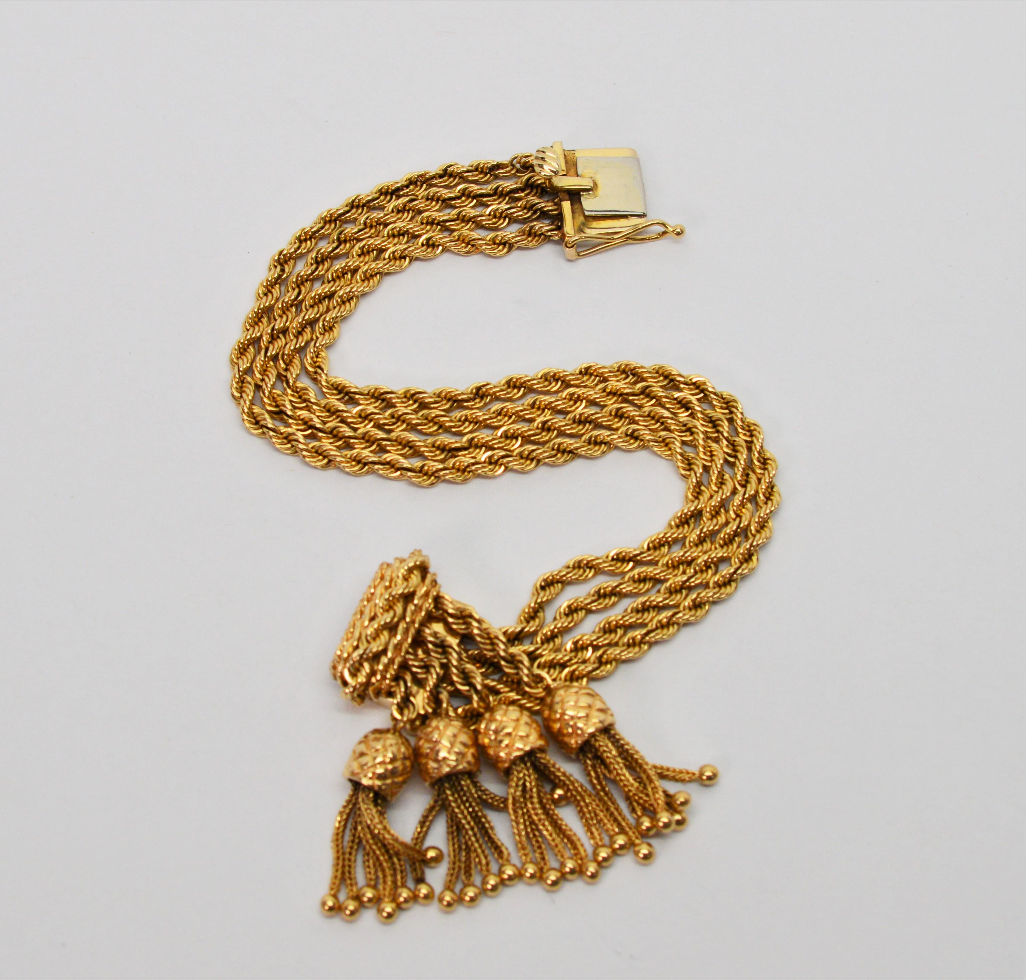Movement and design are the strength of this piece. All in fourteen carat 14K yellow gold, this unique 6-7/8 inch bracelet is crafted with four lengths of glistening rope chain that give fluid body to the one half inch wide piece. The ornate box
