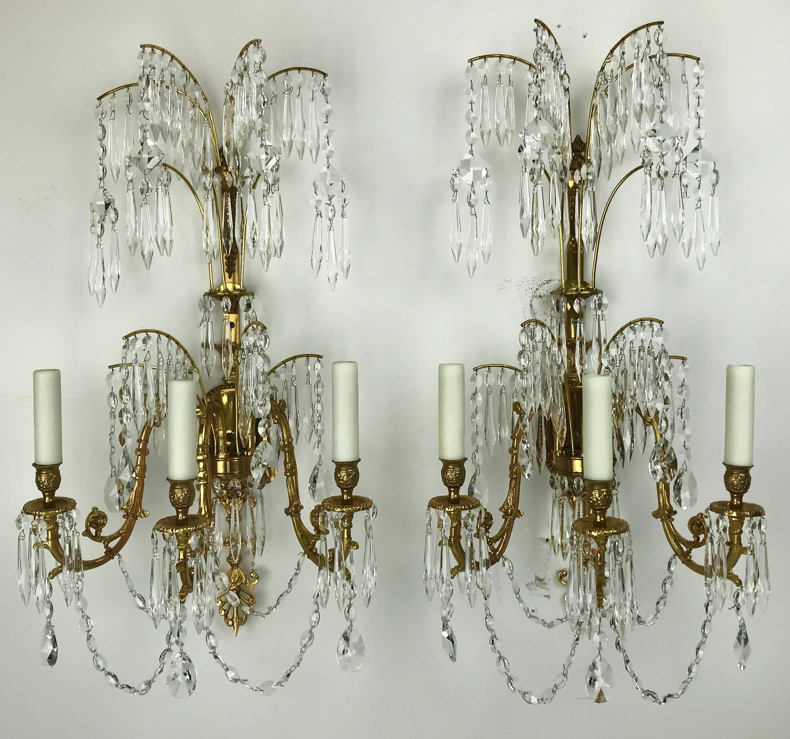 This handsome set of four sconces feature cut crystal swags, pendants, and
crystal fringed branch form elements.