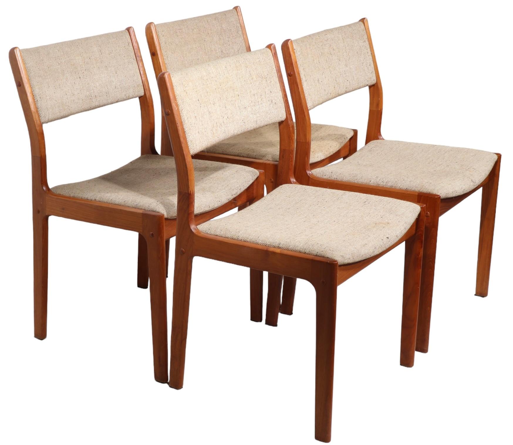 Chci architectural dining chairs, executed ninth Danis style but actually made in Singapore, circa 1950-1960's. The set consists of four side chairs, having solid teak frames, and tweed upholstery seats and back rests. All are structurally sound and