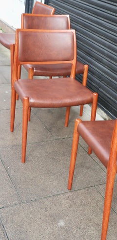Four teak framed Niels Moller Model 80 Chairs, in tan vinyl upholstery