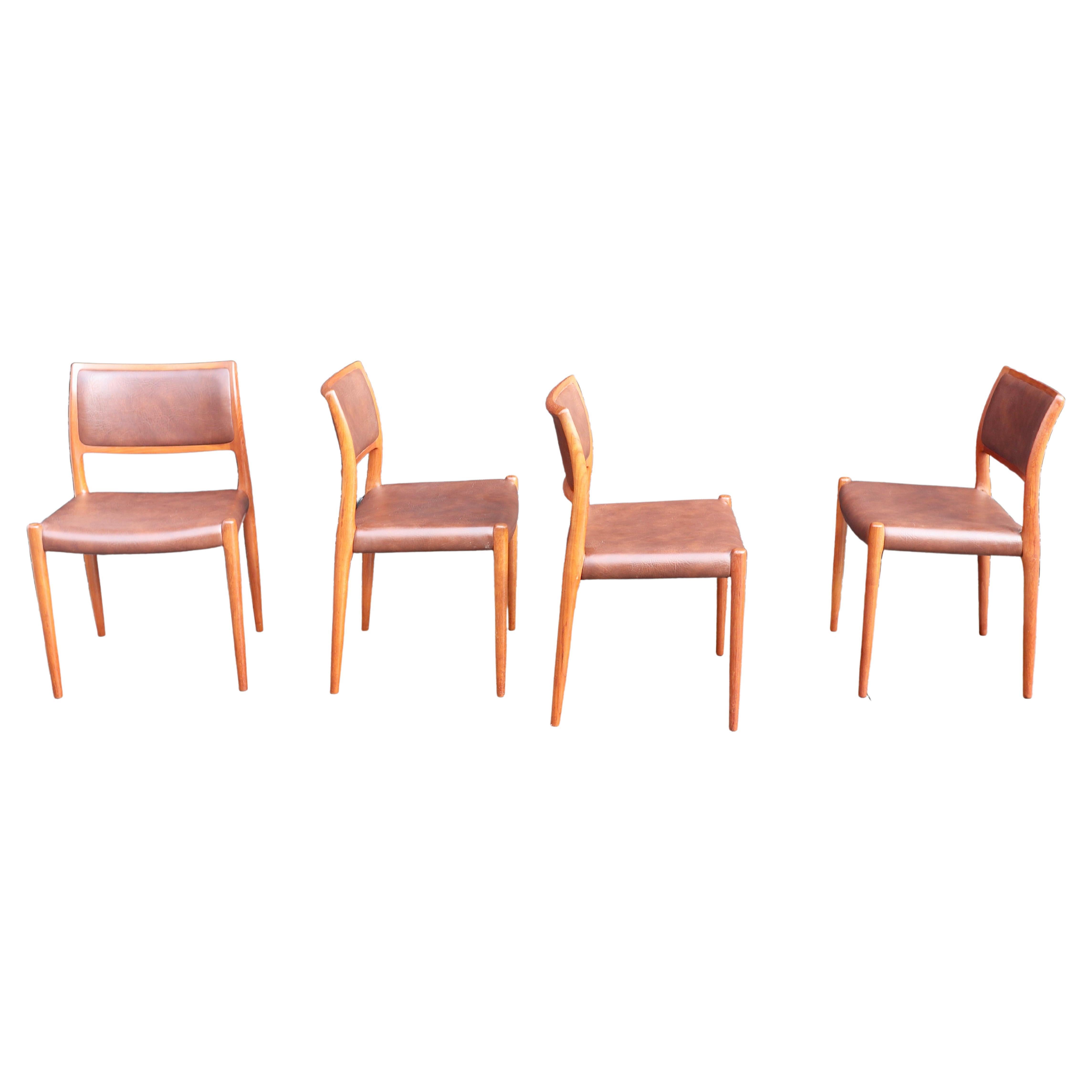 Four teak framed Niels Moller Model 80 Chairs, in tan vinyl upholstery 