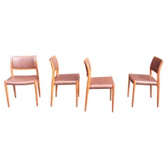 Four teak framed Niels Moller Model 80 Chairs, in tan vinyl upholstery