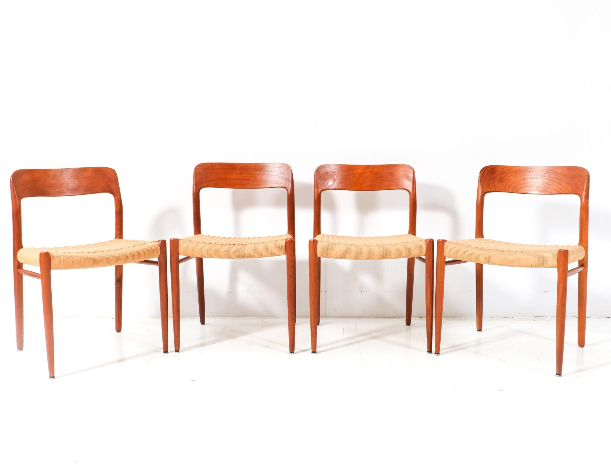 Stunning and elegant set of four Mid-Century Modern Model 75 dining chairs.
Design by Niels Otto Møller for J.L. Møllers Møbelfabrik.
Striking Danish design from the 1950s.
Solid teak frames with the original papercord seating.
This wonderful set of
