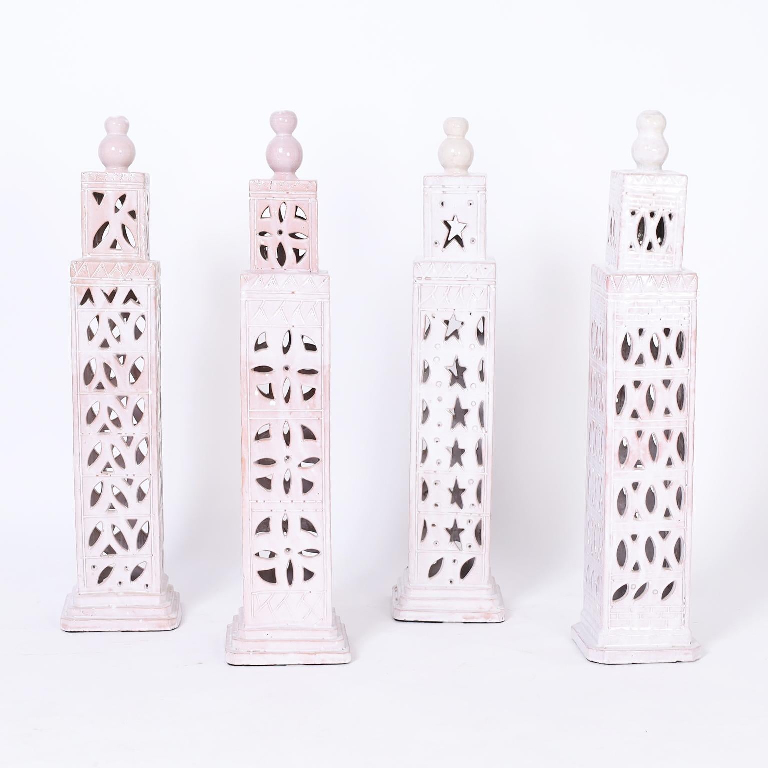 Moroccan set of four white glazed terra cotta candle covers or objects of art in the classic form of minarets.