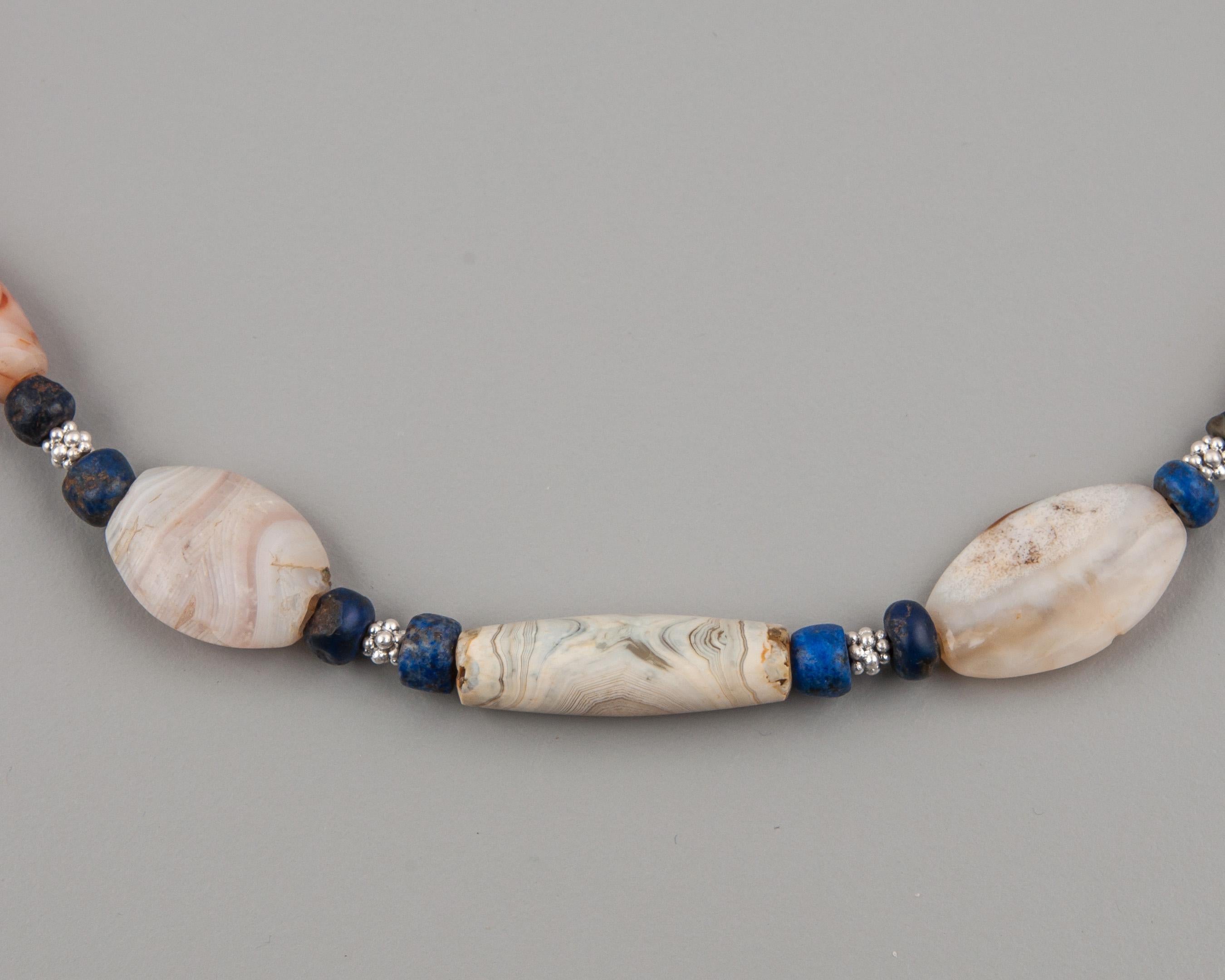 Fifteen agate beads, forty-two lapis lazuli beads and eighteen granulated silver beads. The agate beads are from the early Bronze Age. They are at least four thousand years old (and some are older). Between each of the larger beads is a group of