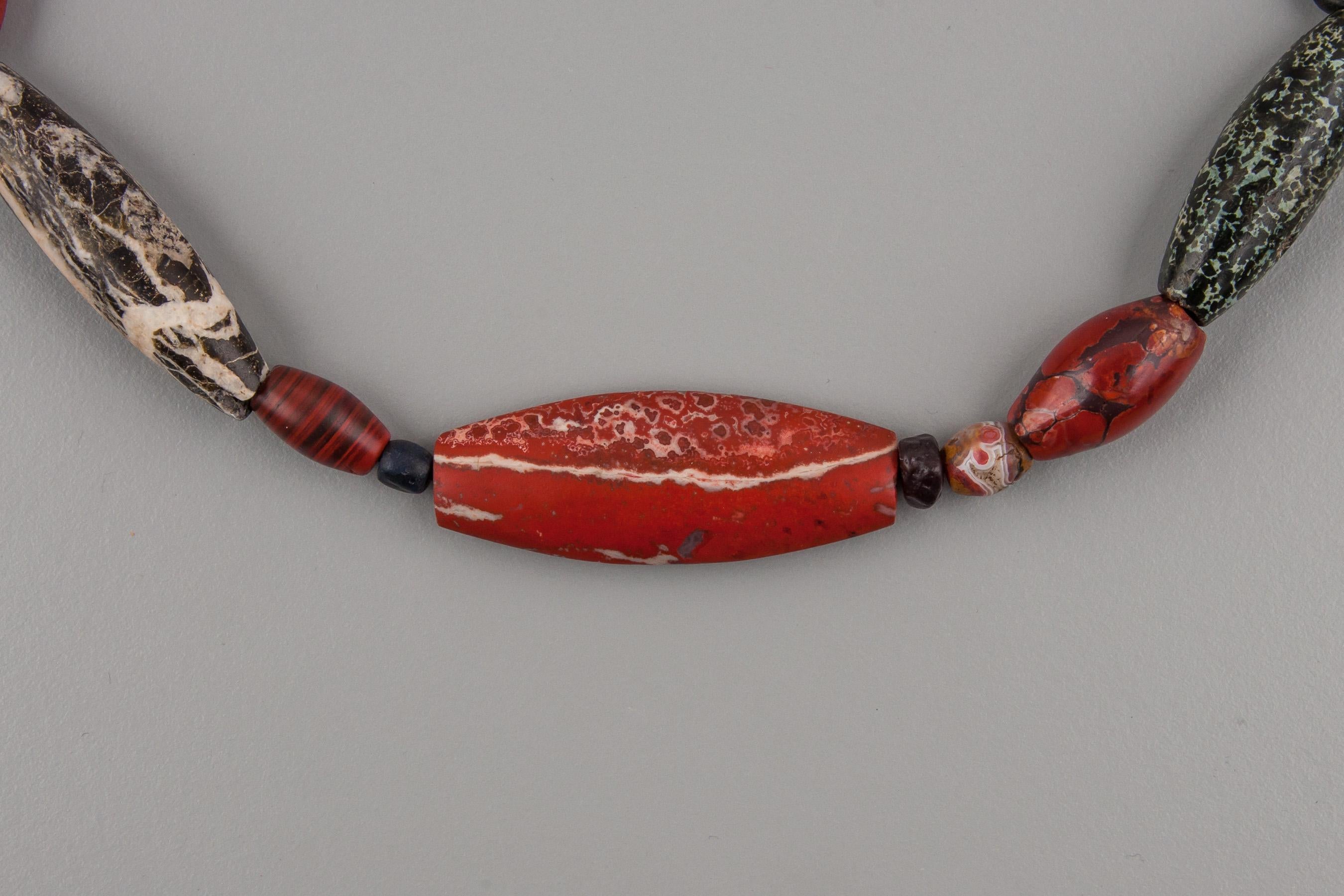 Twenty-eight ancient Bronze Age agate, jasper and alabaster beads. The beads have been selected to make a necklace with just the colors of red, black and white. The beads are from Baluchistan, Pakistan, and north India along the northwestern part