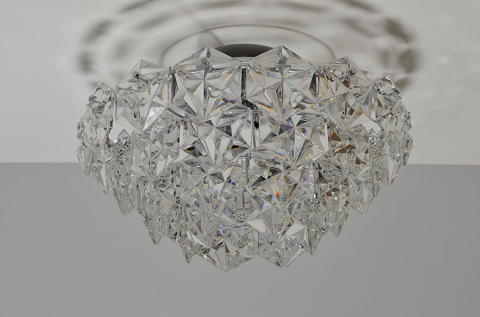 This flush mount with faceted crystal and chromed metal was produced by Kinkeldey Germany in the 1970s. 
Four-tiered and featured with 42 crystals.
 