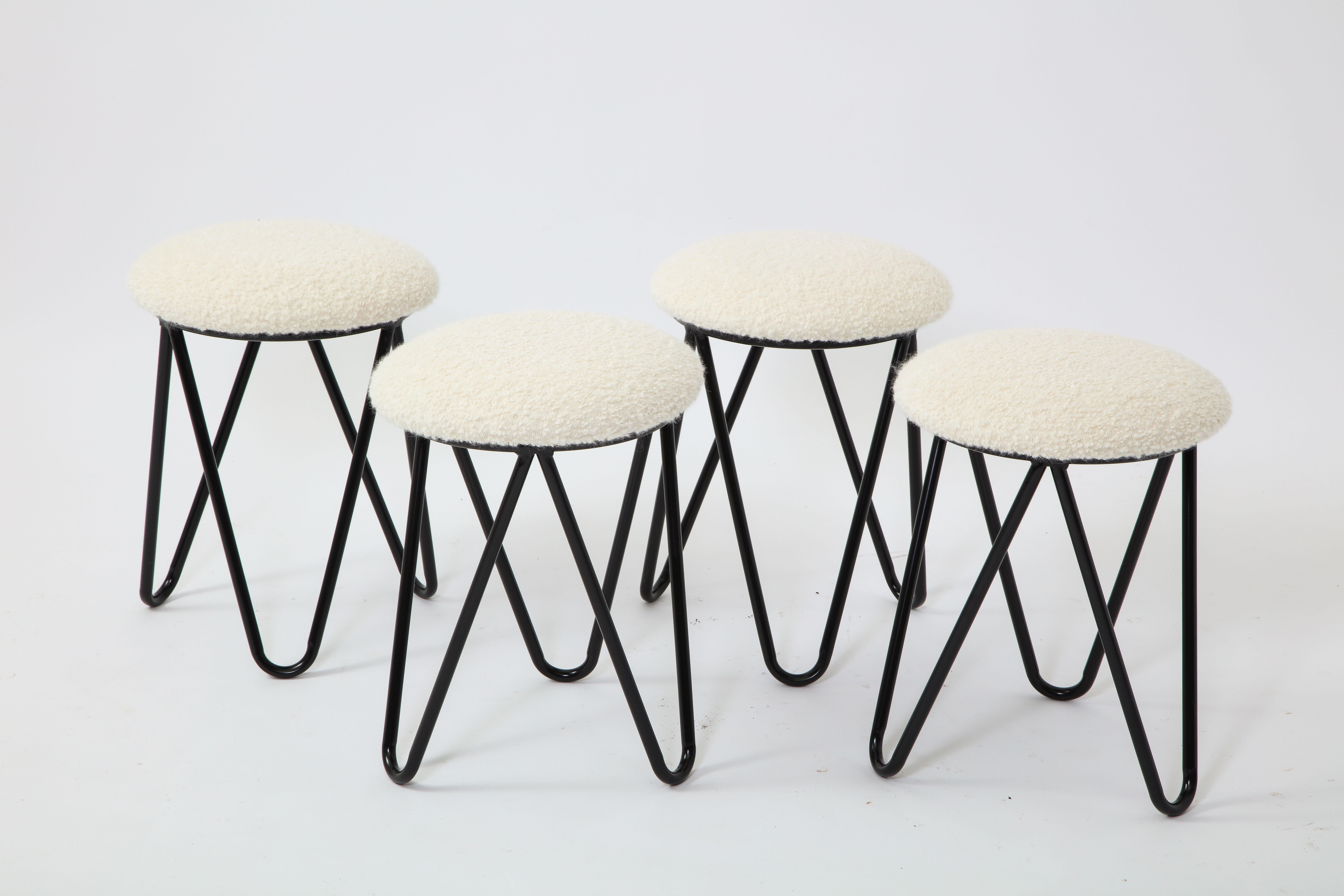 Set of enameled tripod stools in wrought iron with new upholstered tops. Sold in pairs.