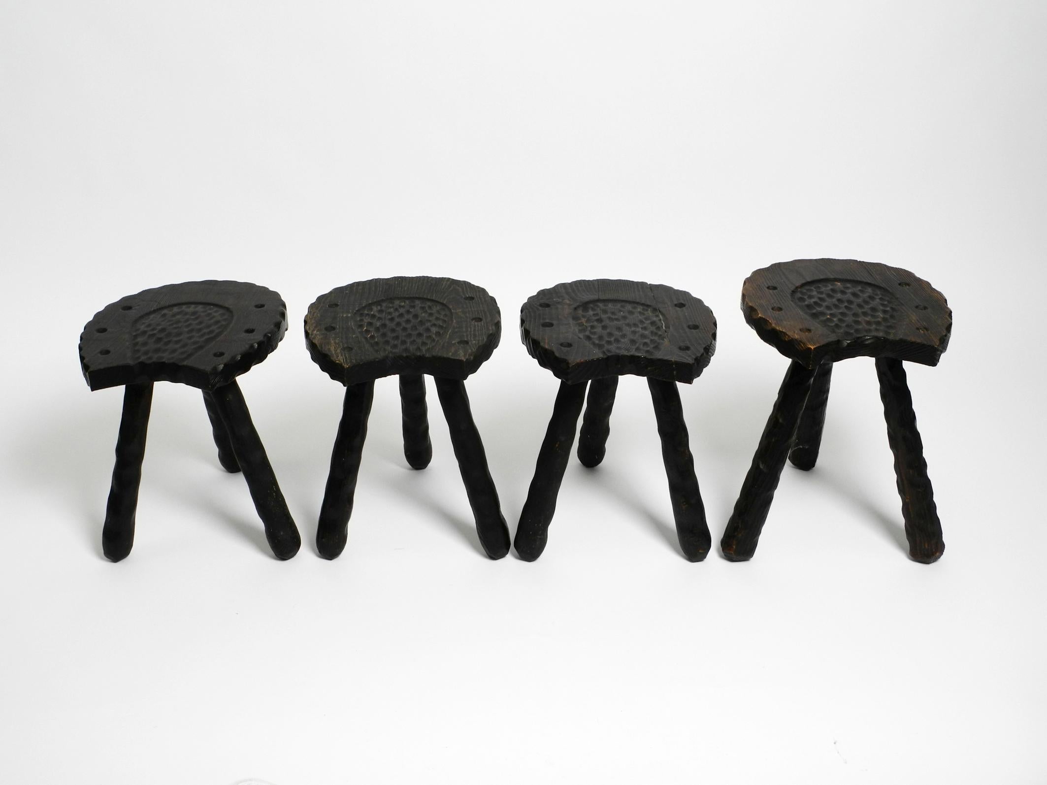 Four unusual Mid Century hand-carved three-legged stools in the shape of a horseshoe.
Made from pine wood stained dark brown.
Without damage with a beautiful patina. Not wobbly.
Legs can be unscrewed.
One stool is 3 cm higher than the other