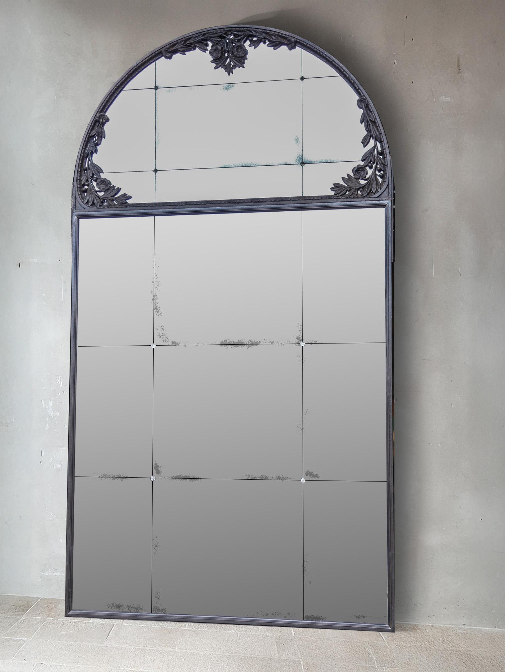 This set consists of four large mirrors featuring an iron frame with distinctive arches, filled with aged mirror glass in a patchwork pattern and finished with elegant glass rosettes.

What makes these imposing arched mirrors particularly special