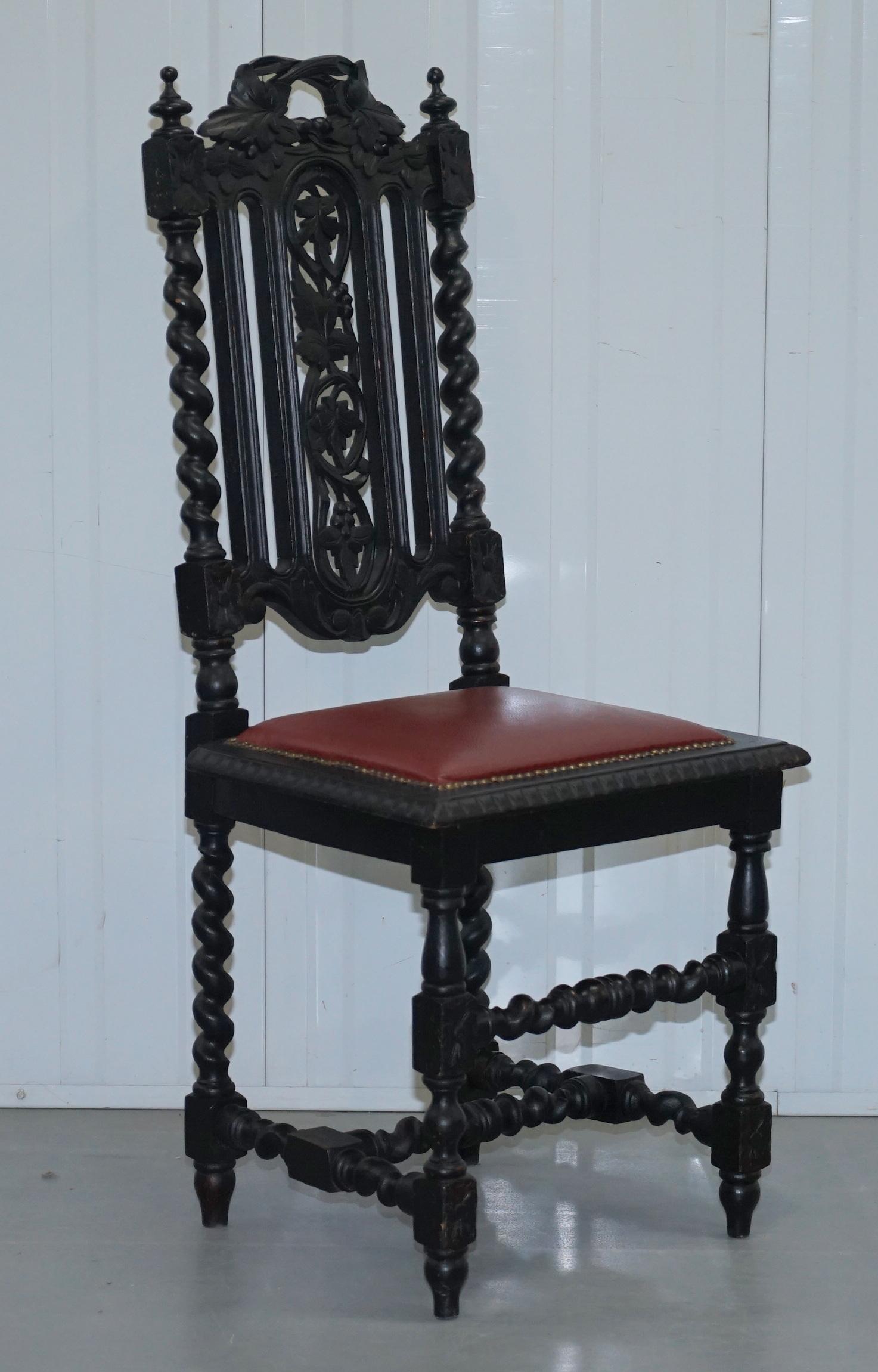 We are delighted to offer for sale this set of four Gothic-style Victorian hand carved English oak dining chairs with leather upholstery and ebonized black frames

The chairs have barley twist legs, ornate Jacobean / Gothic style carvings all