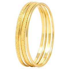 Four Vintage 14 Karat Yellow Gold Decorated Bangle Bracelets