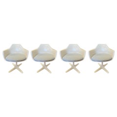 Four Retro Burke White Fiberglass Swivel Dining Chairs