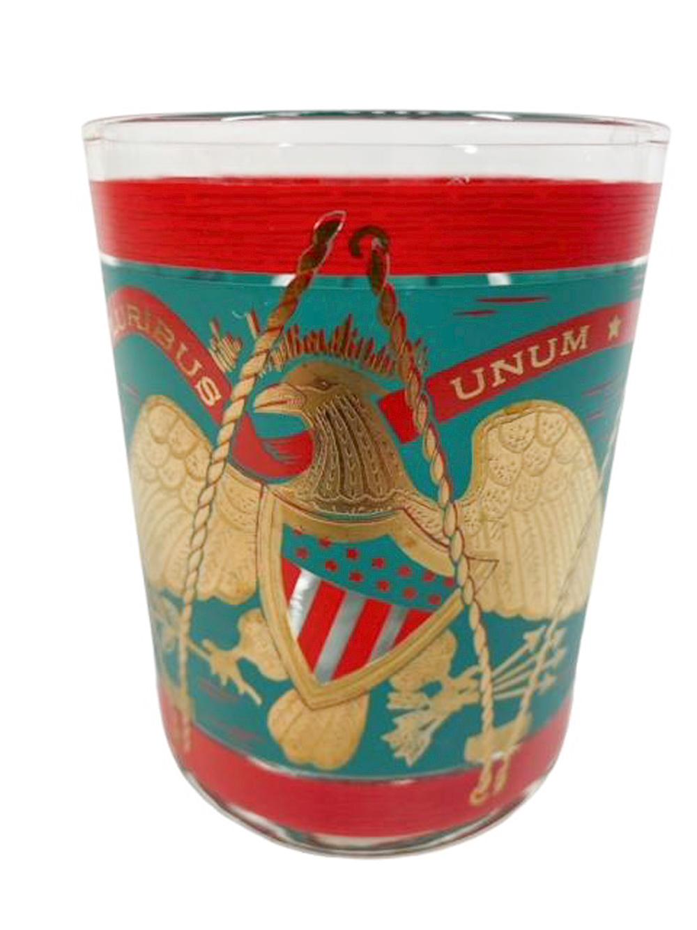 Four vintage rocks glasses by Cera, decorated as a teal and red parade drum with a spread-wing eagle holding a stars and stripes shield on the front and with a shield on the back.