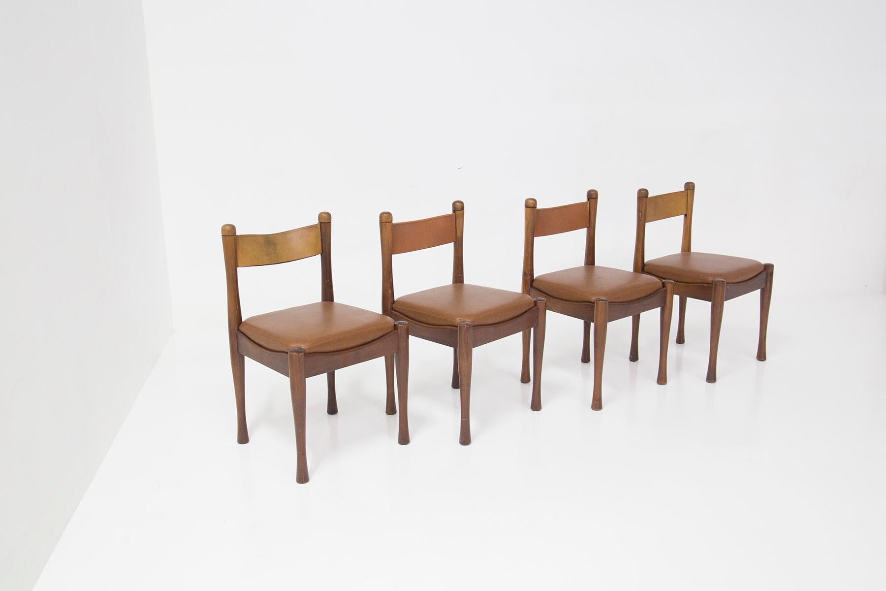 Elegant Set of 4 chairs designed by Silvio Coppola for the Italian manufacture Bernini. Below the chair we find its original manufacturer's label. Made in 1970. Sturdy wooden frame , the wooden legs appear to have been turned given their sinuosity.