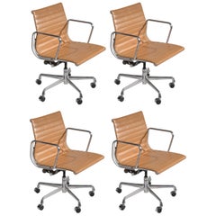 Four Vintage Eames Aluminum Group Leather "Management" Chairs in Tan Leather