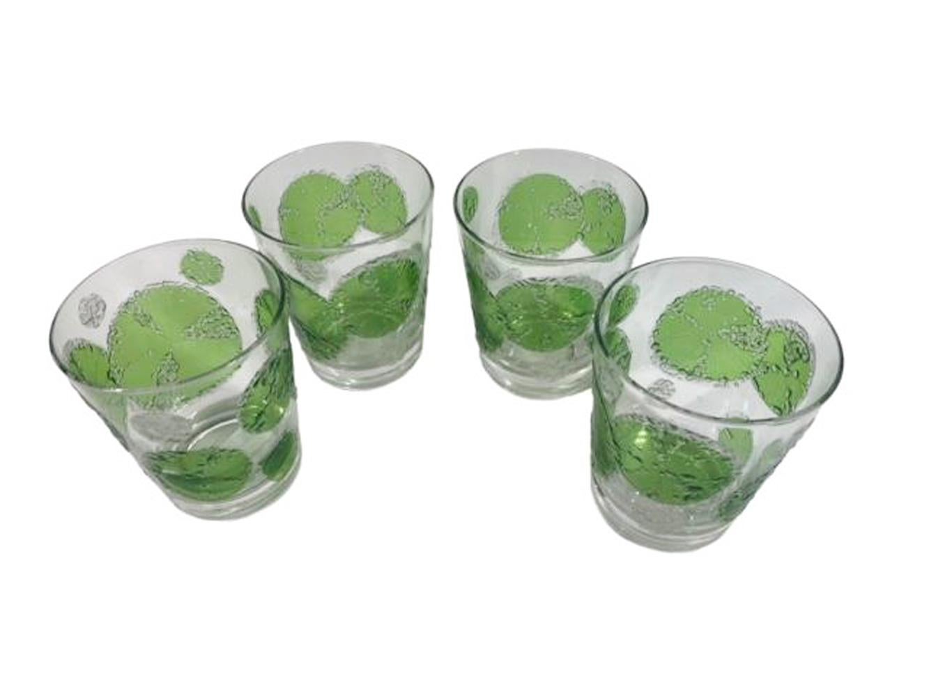 Set of four mid-century modern double old fashioned glasses designed by Fred Press with translucent green lime slices having edges in raised sugared texture in clear and white.