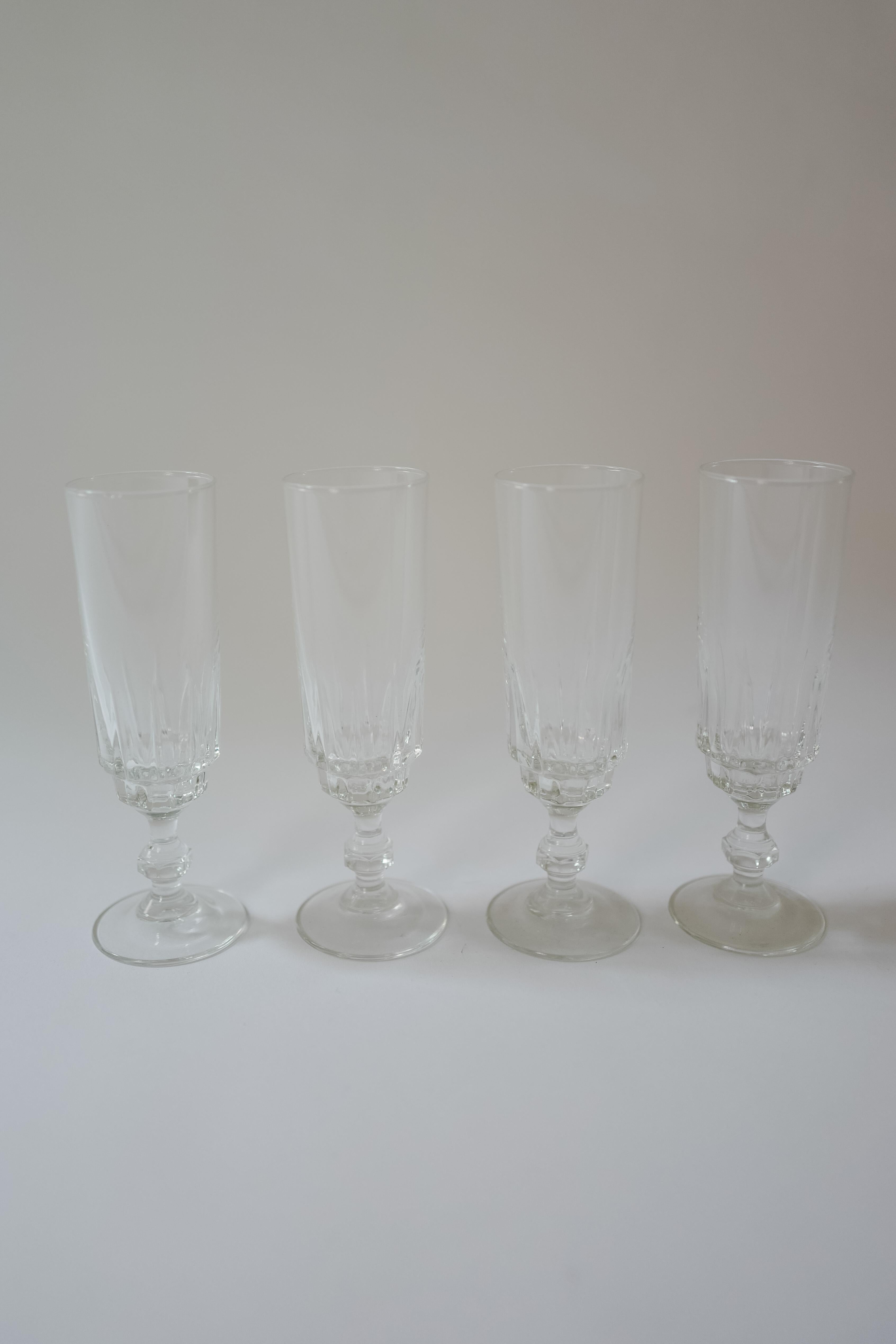 A set of four vintage crystal French glass champagne flutes. Marked France on the base of the glass. 