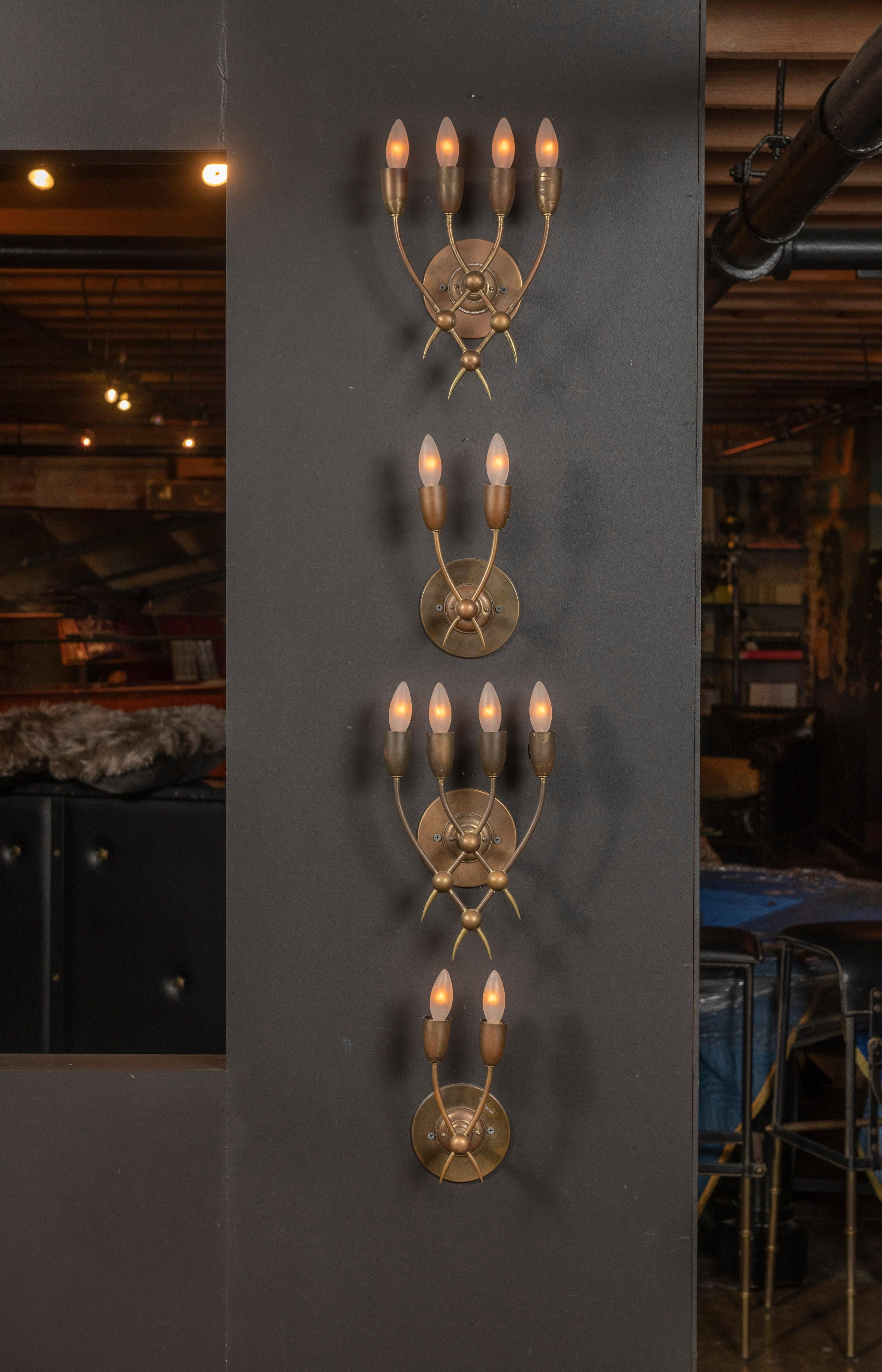 Pair of brass sconces manufactured by Guglielmo Ulrich in Italy circa late 1930s - early 1940s. Wired for US junction boxes. Each sconce takes four E14 European candelabra bulbs. Gorgeous patina.

Second pair of sconces seen in photographs appear