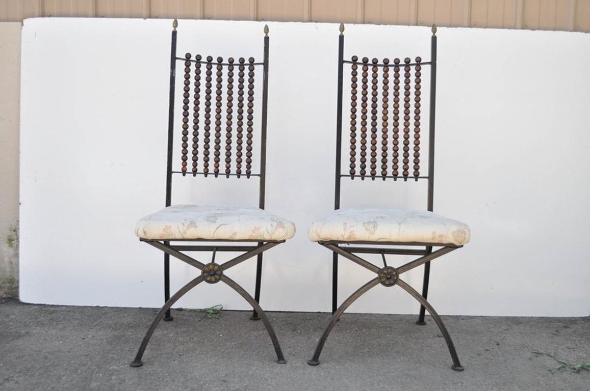 Set of four unusual vintage Hollywood Regency Abacus back metal side dining chairs. The chairs feature wood beaded Abacus style backs, stretcher supported X-form front legs, and lovely brass acorn finials. A very attractive set of chairs,
circa