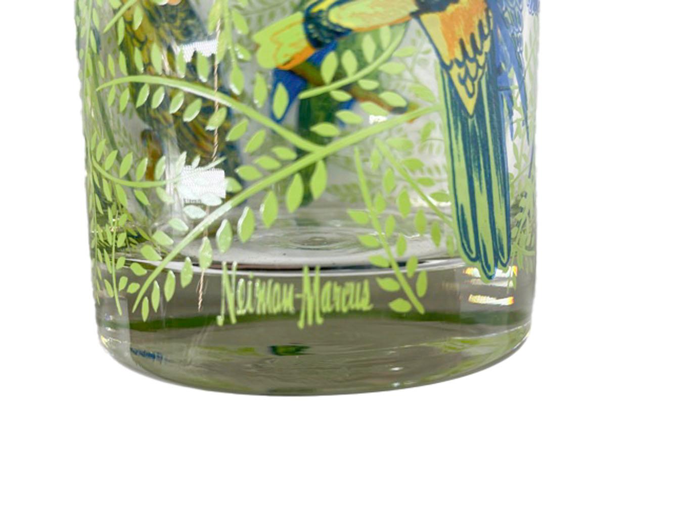 Four large vintage rocks glasses with brightly colored parrots sitting among leafy branched. Private labeled for Neiman Marcus and likely made by Cera Glass.