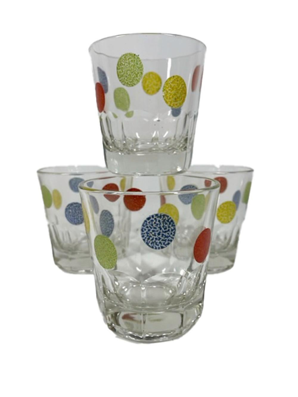 Set of 4 vintage rocks glasses with paneled bases decorated with raised, textured enamel dots in green, yellow, blue and red.