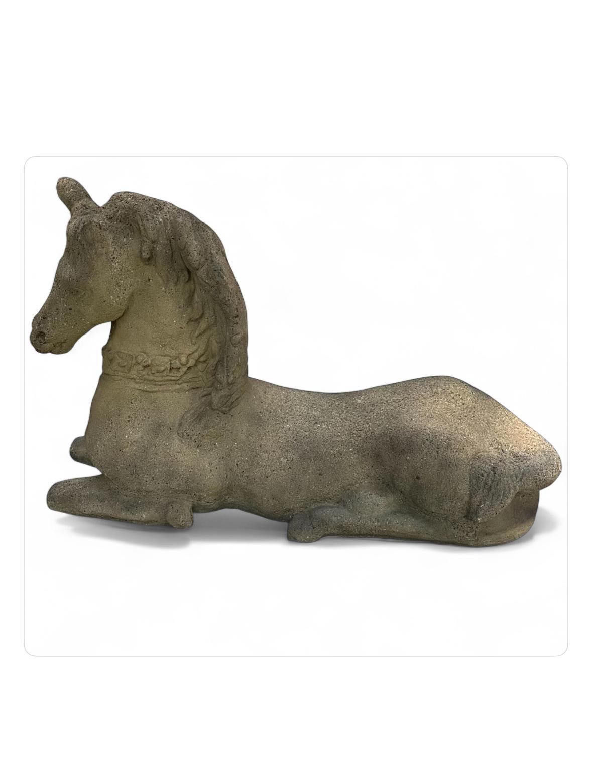 Four Vintage Stone Horse Garden Statues.

Impressive set of four concrete recumbent horse statues. They are modeled with flowing manes and jeweled harness around the neck.
In good vintage condition. Minor losses. One missing ear, one ear
partly