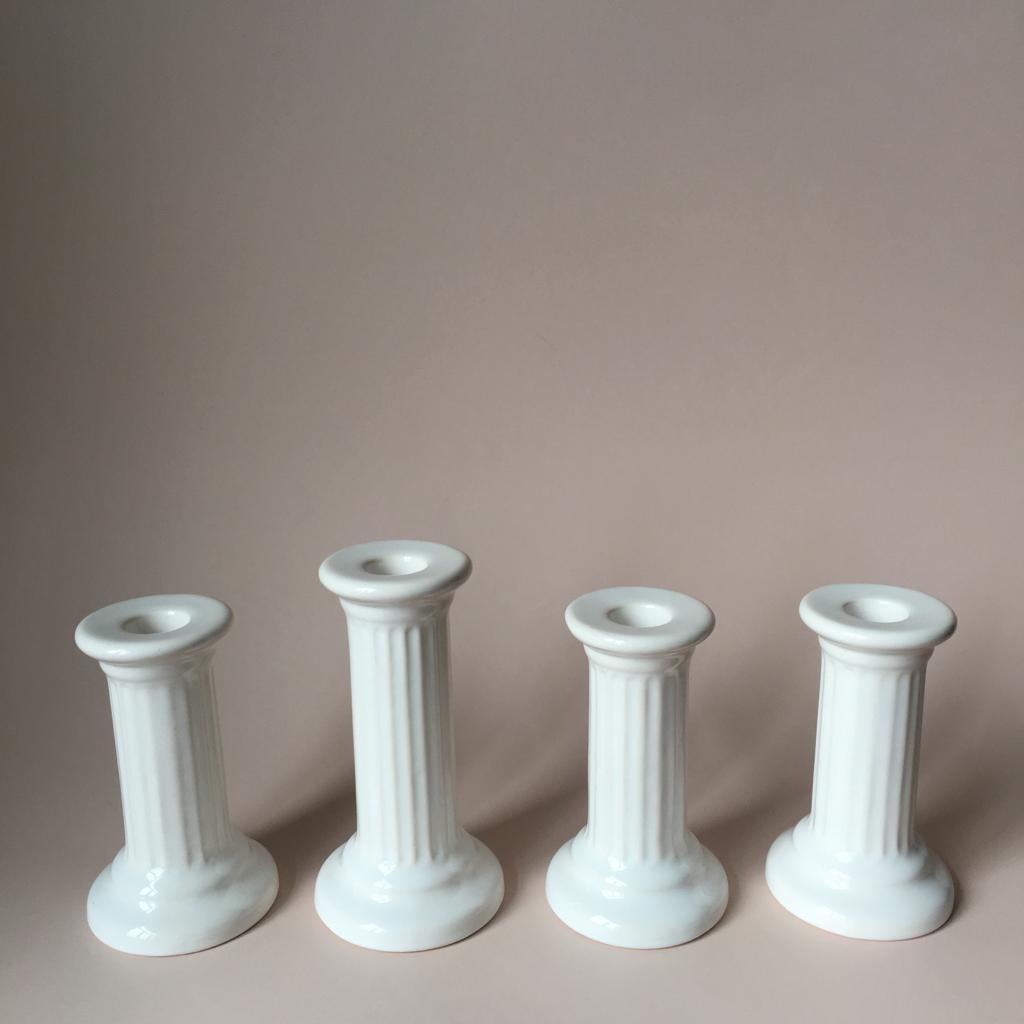 This set from Guldkroken Hjo Sweden consists of three columns H 12 cm/D 7 cm and of one - H 14 cm/D 7.5 cm. It features nice soft white color. They are very classical and minimalistic at the same time.