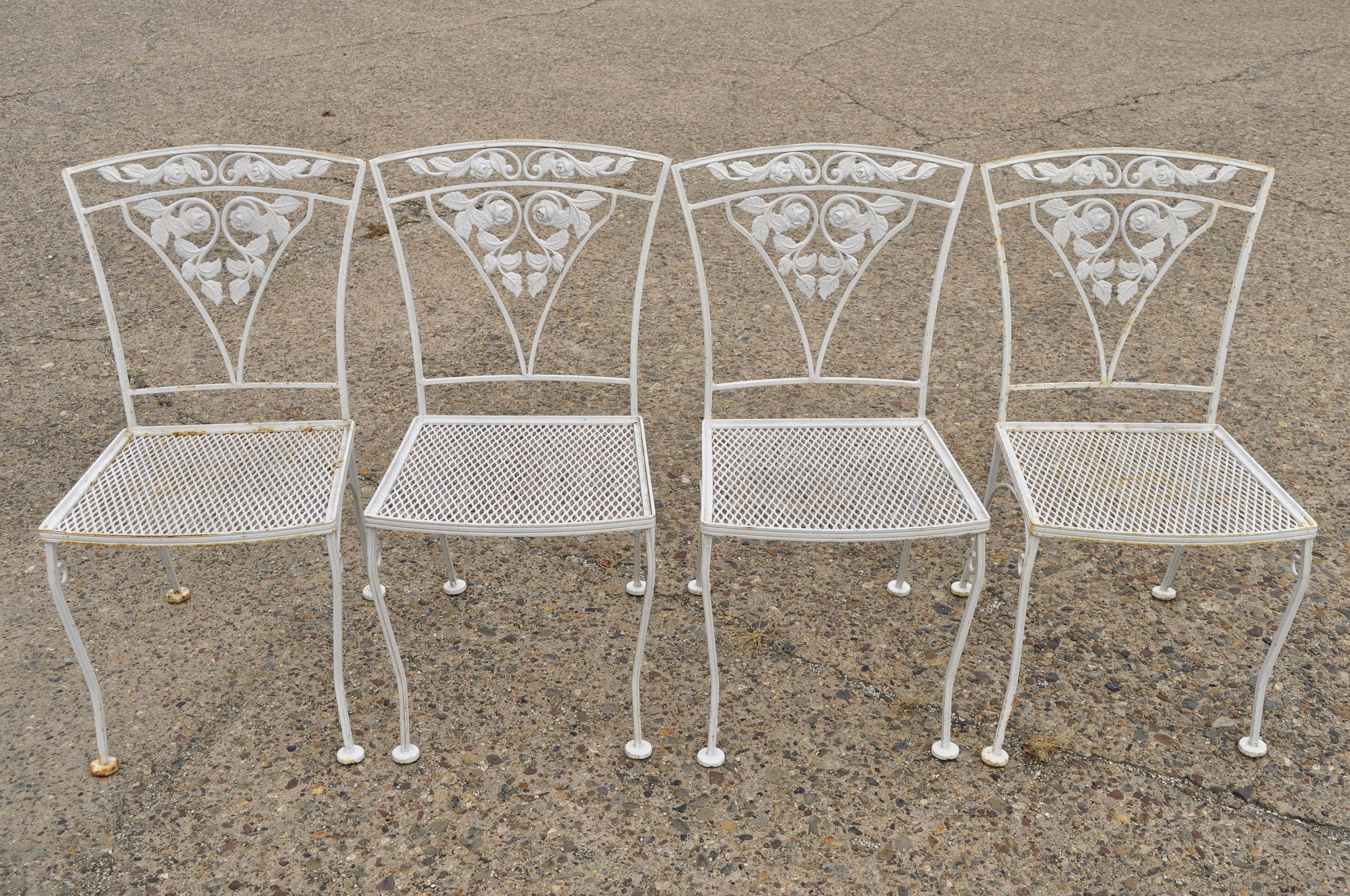 Four Vintage Woodard Chantilly Rose Wrought Iron Patio Garden Dining Chairs. Items feature removable cushions, metal mesh perforated seats, (4) side chairs, wrought iron construction, very nice vintage item, great style & form. Mid 20th.