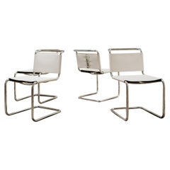 Four White Leather Chairs