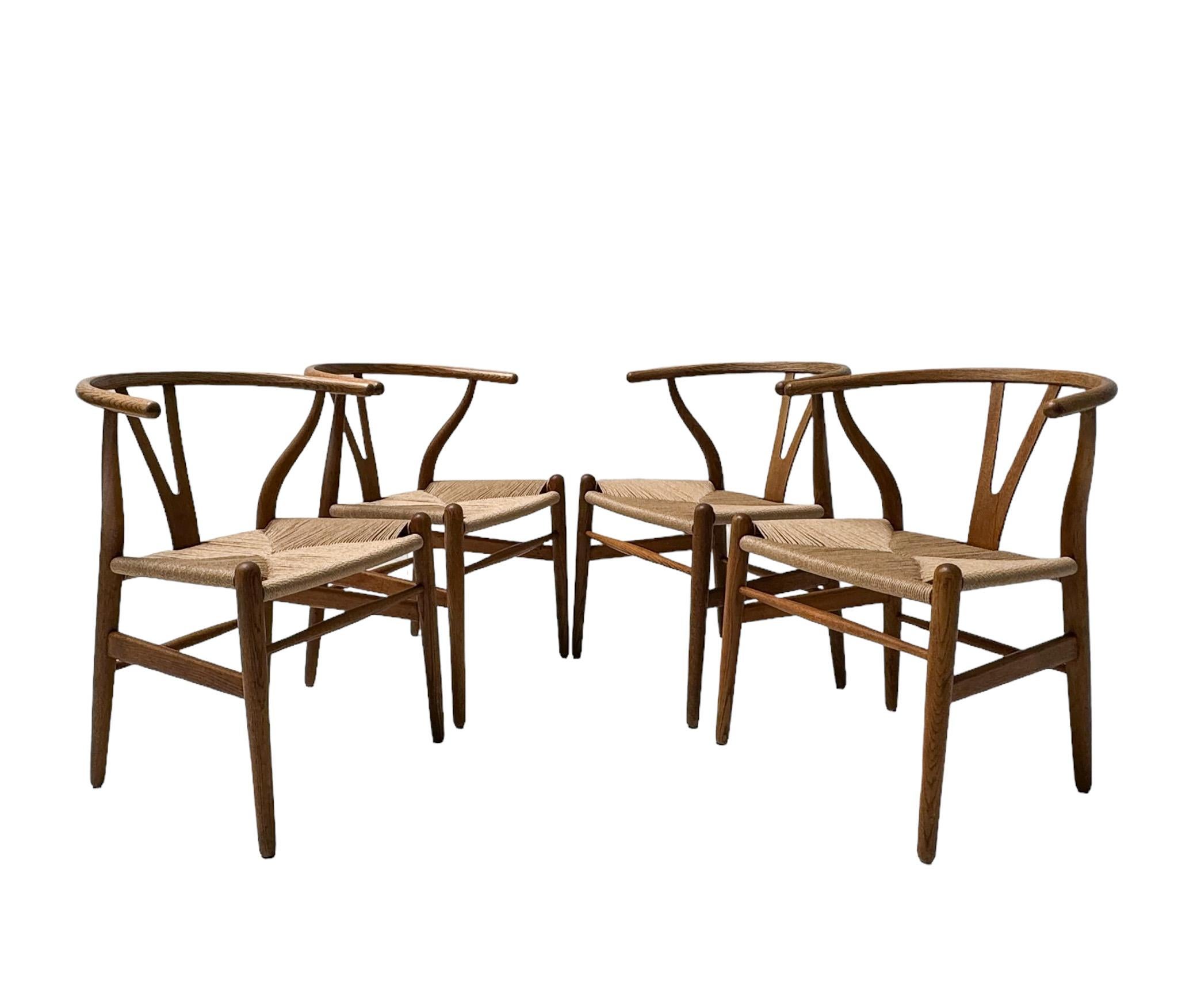 Magnificent and rare set of four Mid-Century Modern Wishbone CH 24 dining room chairs.
Design by Hans J Wegner for Carl Hansen & Søn Denmark.
Striking Danish design from the 1950s.
Solid patinated oak frames with new woven papercord seats.
All four