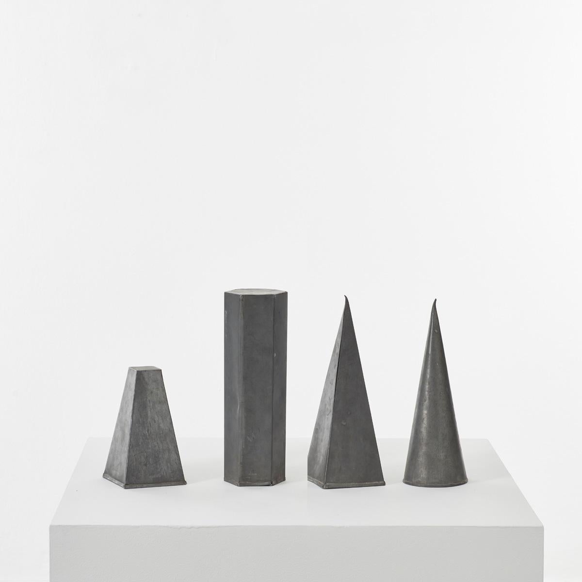 This set of four geometric shapes have been handcrafted from zinc plate. Can be used to add some interesting geometry to a mantelpiece or shelf. Each one has a lovely character showing traces of past use.