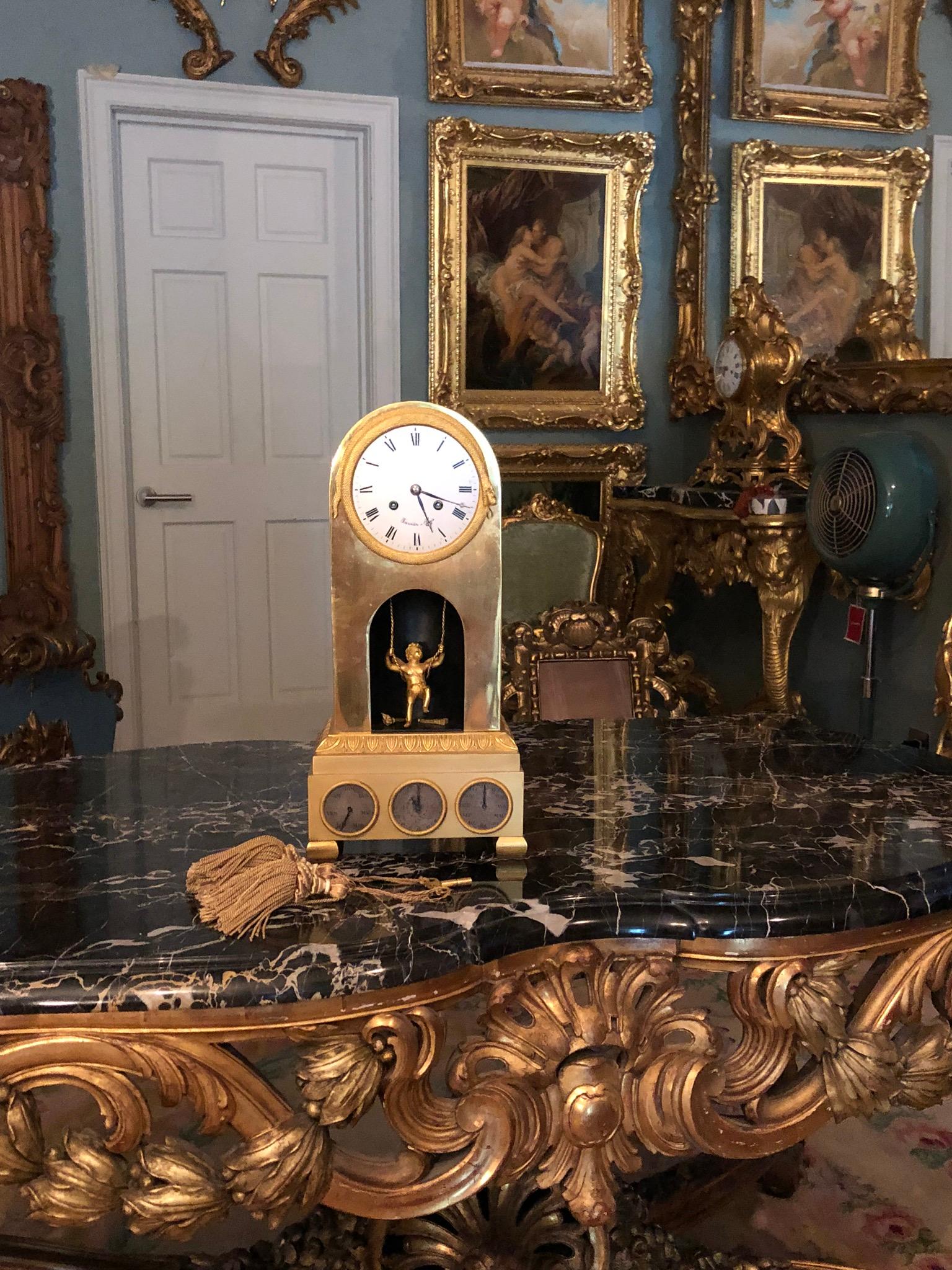 This was a very modern clock in its day From the Maison Fournier, Paris. Gone are the grand Rococo flourishes of Louis XV and in its place are Fine details such as the golden Winged Cupid, swinging on a golden rope, rocking forwards and backwards