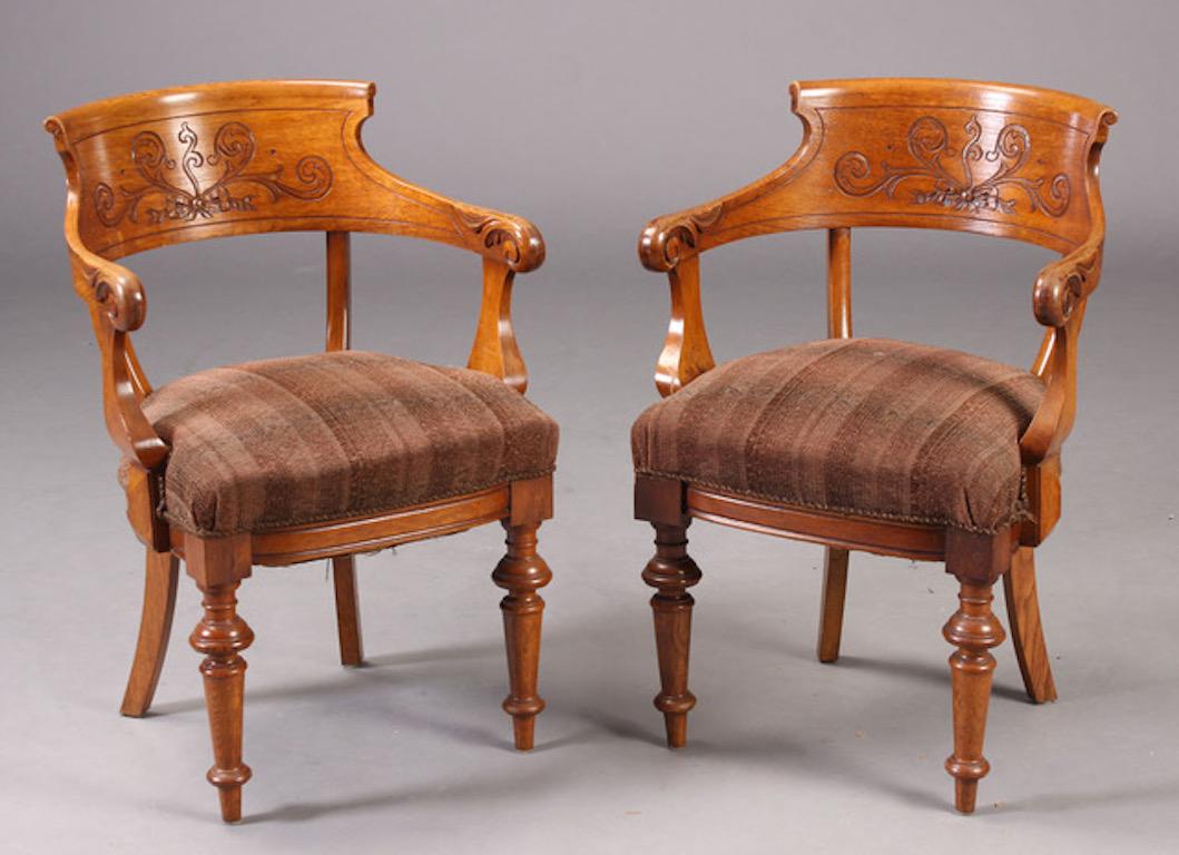 A wonderful set of Aesthetic Movement armchairs, fourteen in all, with carved backs and turned legs in walnut, Danish early 20th century. There are 14 chairs, good for dining, library or club room. Very comfortable and sturdy, with upholstered seats