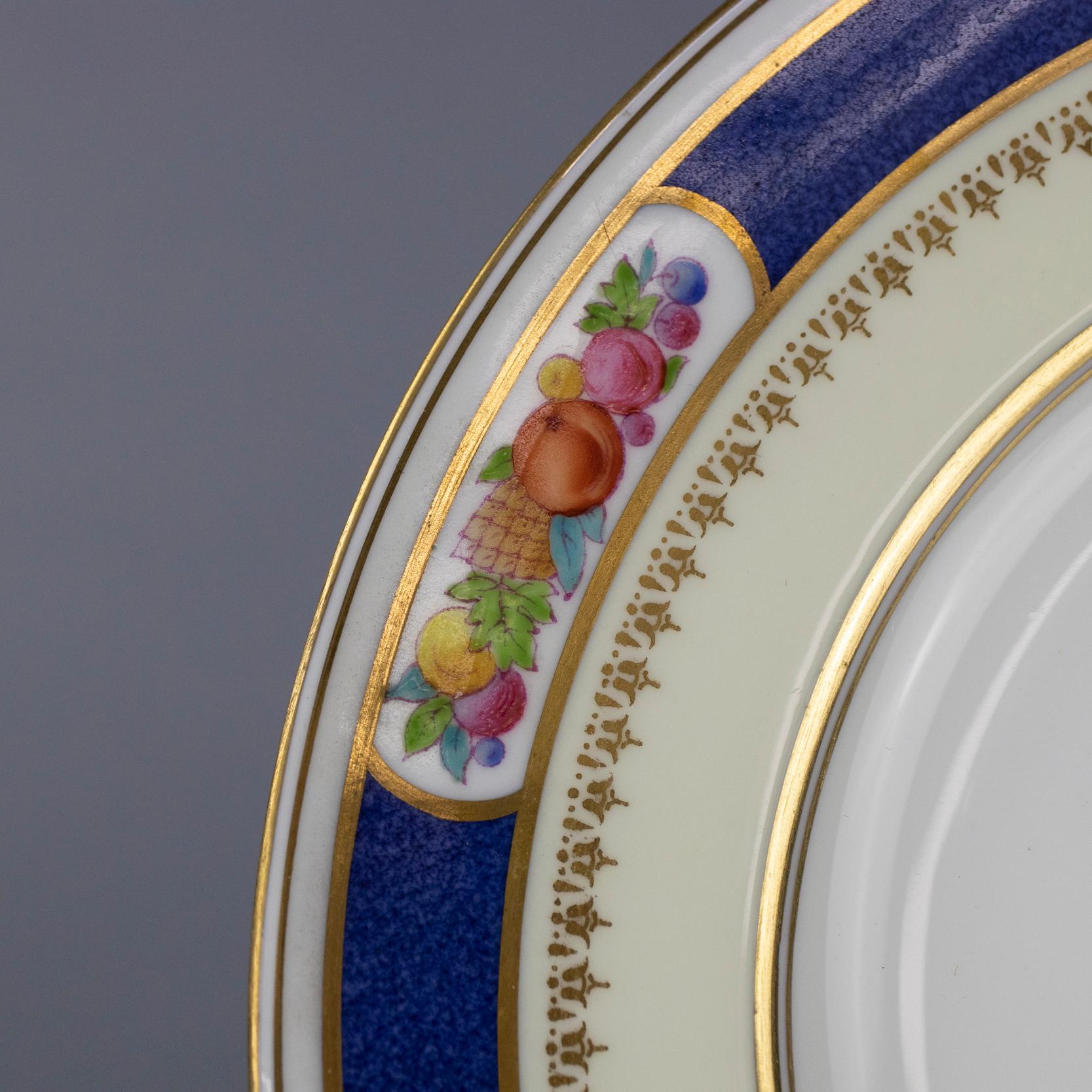 A set of 14 English fine china porcelain salad plates by Wedgwood offer cobalt blue and gilt rim with fruit still life reserves, en verso maker mark as photographed, circa 1940.

Measures: 9