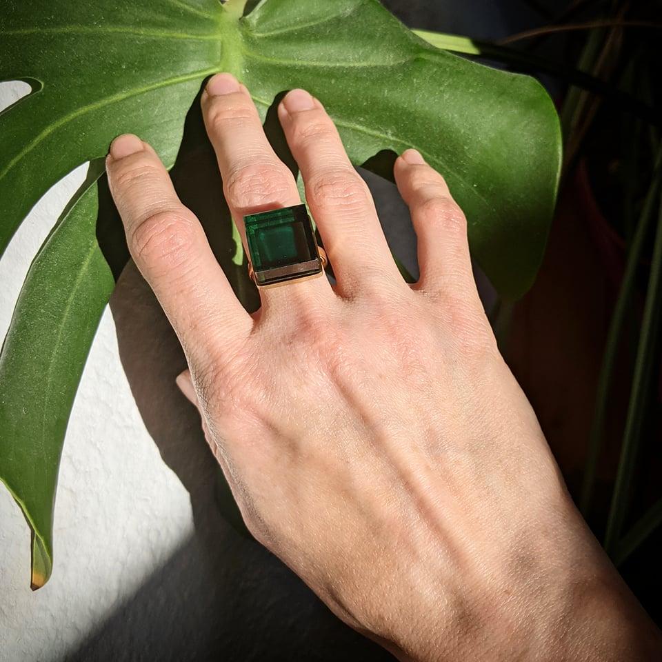 This ring features a striking 15x15x8 mm green grown quartz set in 14 karat rose gold. It has received acclaim from Harper's Bazaar and Vogue UA.

With its bold and timeless minimalistic design, this ring is suitable for both men and women and is