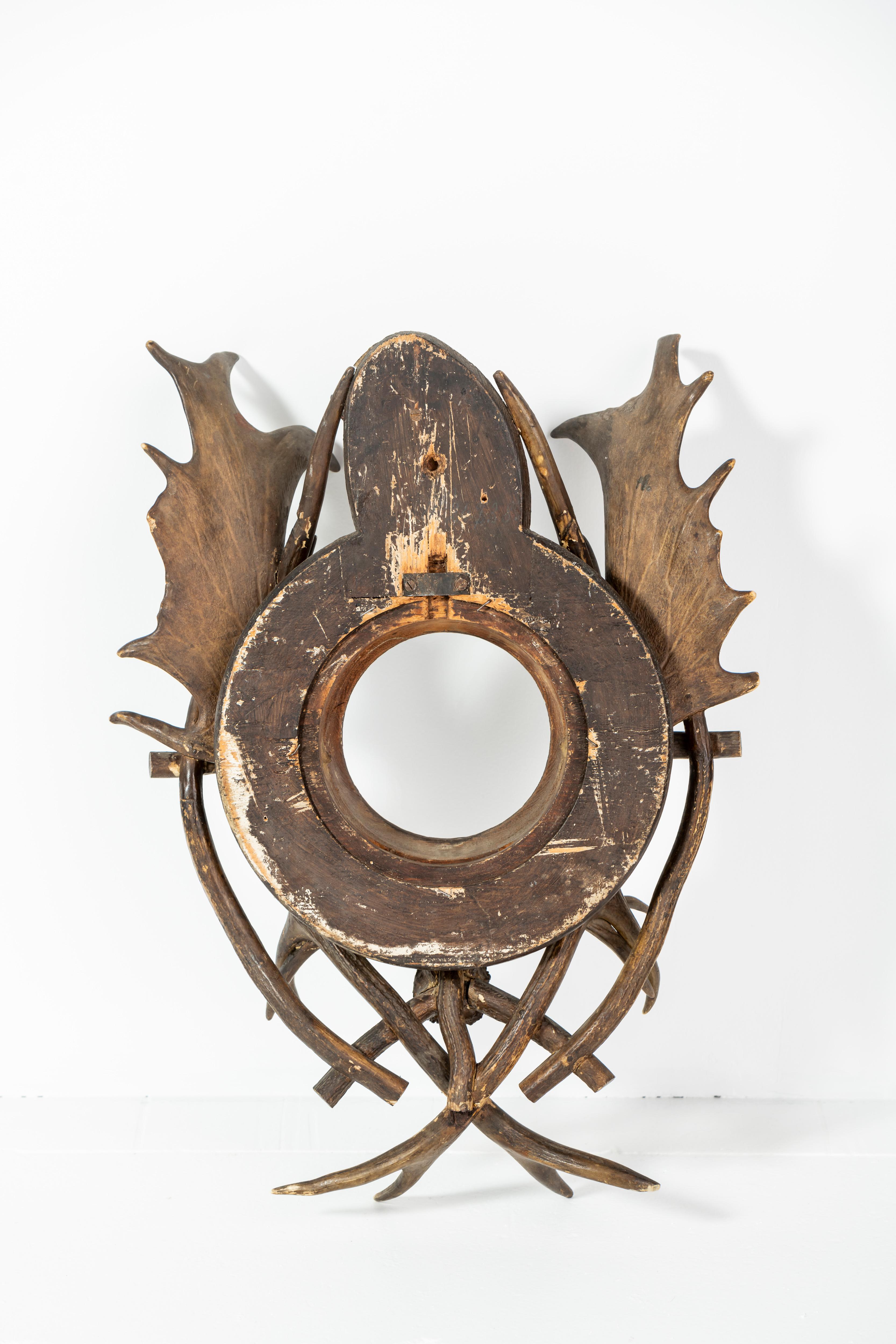 Handmade mirror from wood and antlers - likely European.