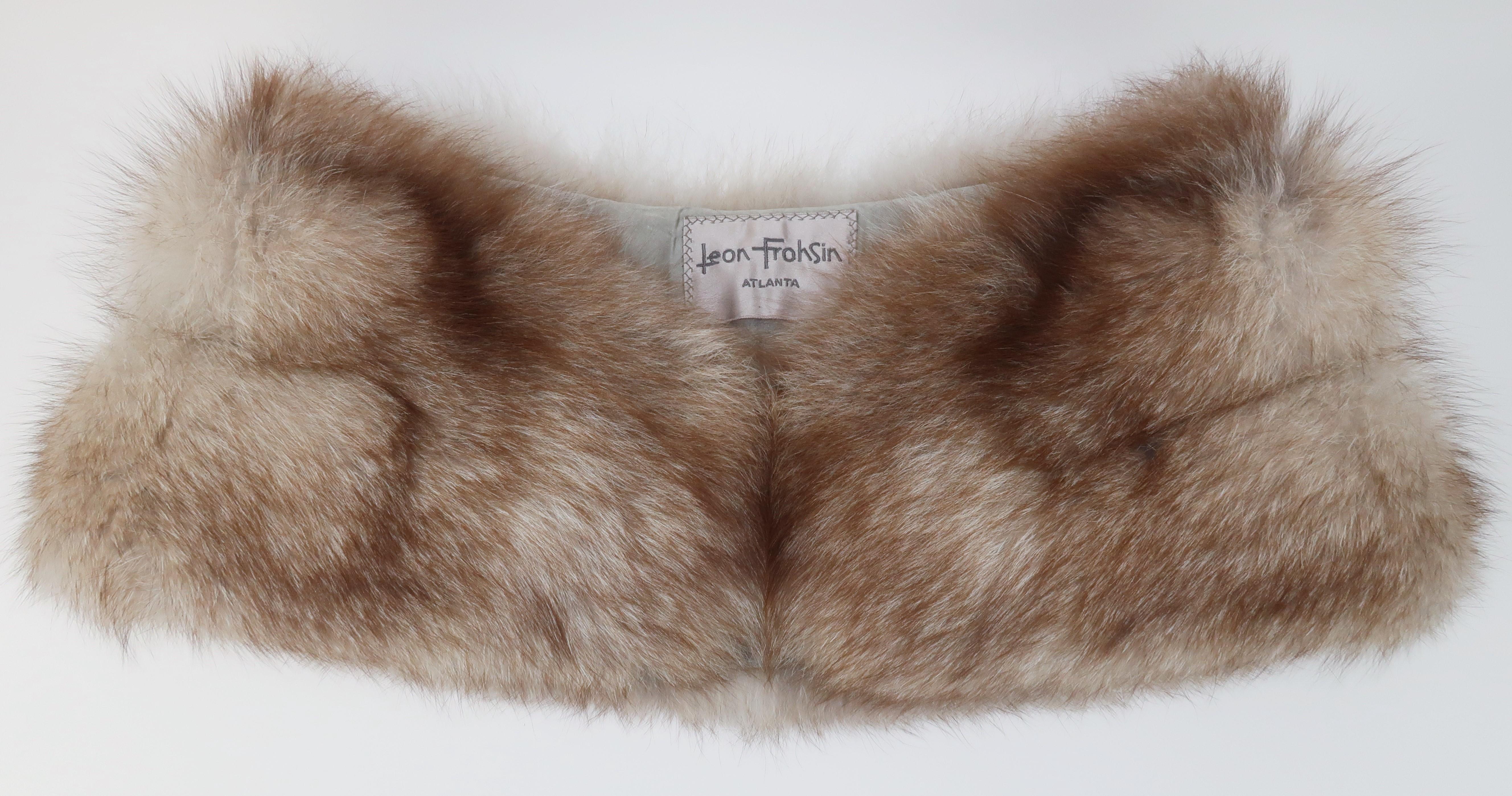 1950's fox fur stole with the versatile shape enabling it to be worn as a collar, shoulder warmer or a classic wrap.  The lush fur displays shades of grayish white and light brown with hints of red.  The backside is lined in a neutral grayish taupe