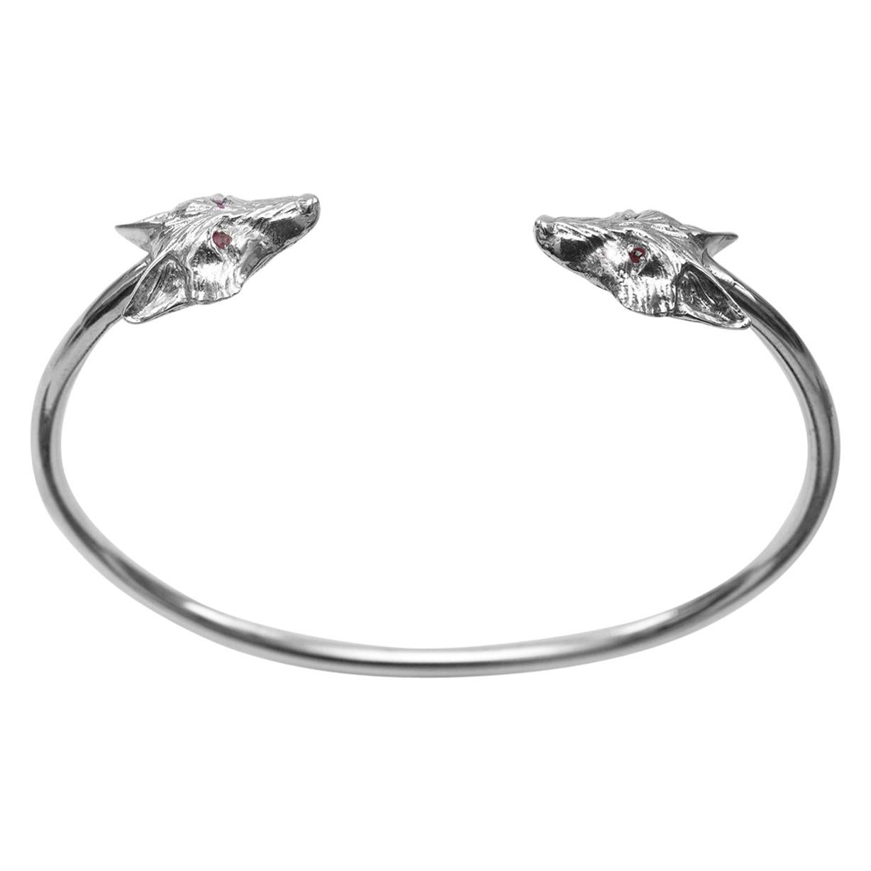 A striking Fox bangle in solid Sterling Silver, with Rubies.

This sturdy but feminine Fox bangle was made to mark Simon Kemp Jewellers' 25th Anniversary.

The crisp combination of Silver and Rubies lends this bangle a simplicity which lets the