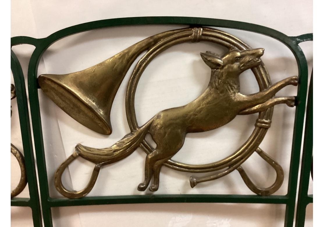 The celebrated Fox Hunt Bench design from Kenneth Lynch and Sons with Brass back panels depicting Classic Hunt iconography of Fox, Horn and Whips. Very well made with a Green Painted welded aluminum frame and Cumaru Wood seats. With good weight and