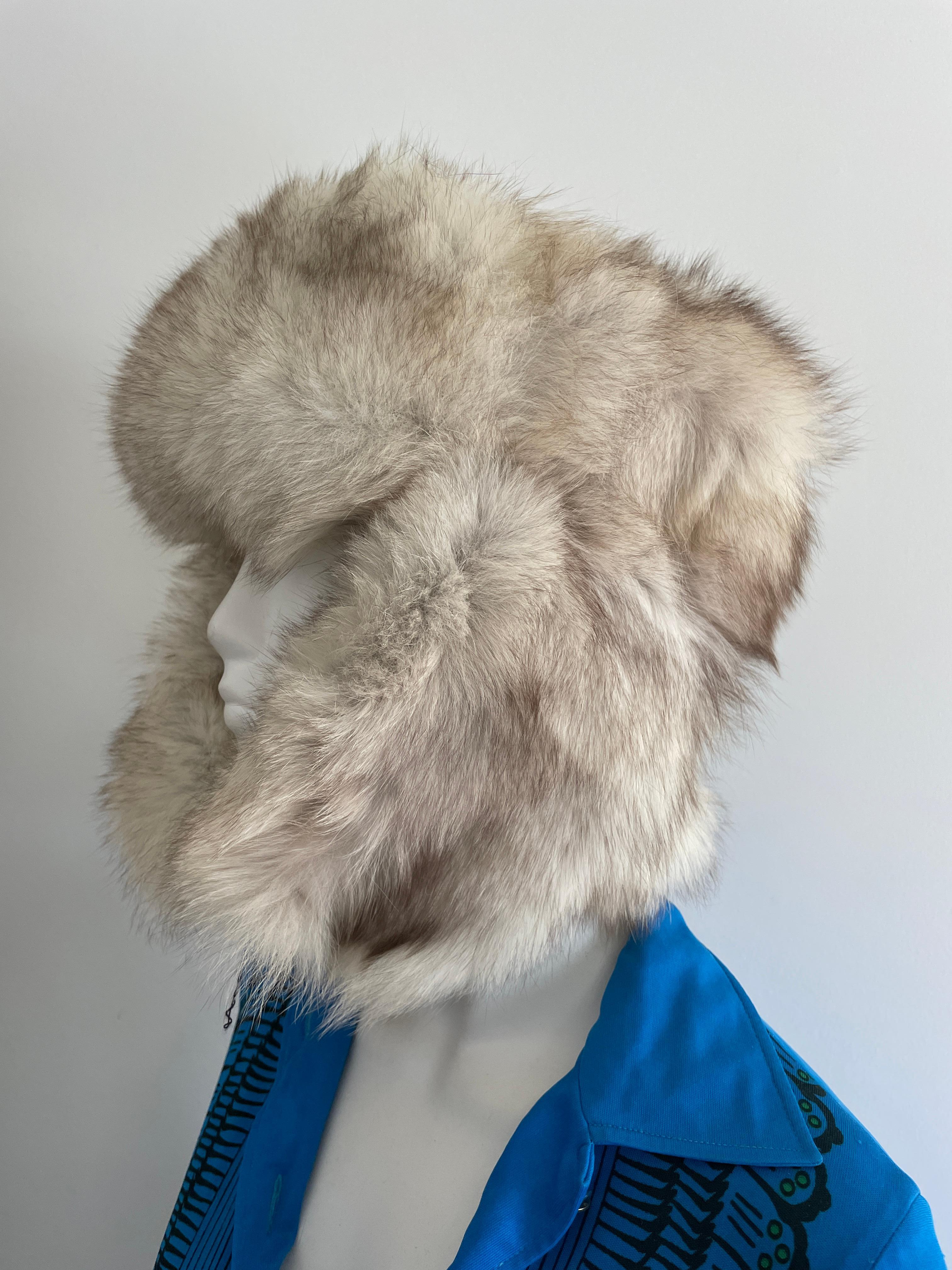 Fox Fur Trapper hat with ears.  This is a 22 in. This has a  string that is used to tie at your chin or tie above your head. We have more fox hats listed. In nice condition.  Please be sure to check our storefront for more furs from Mink, Fitch,
