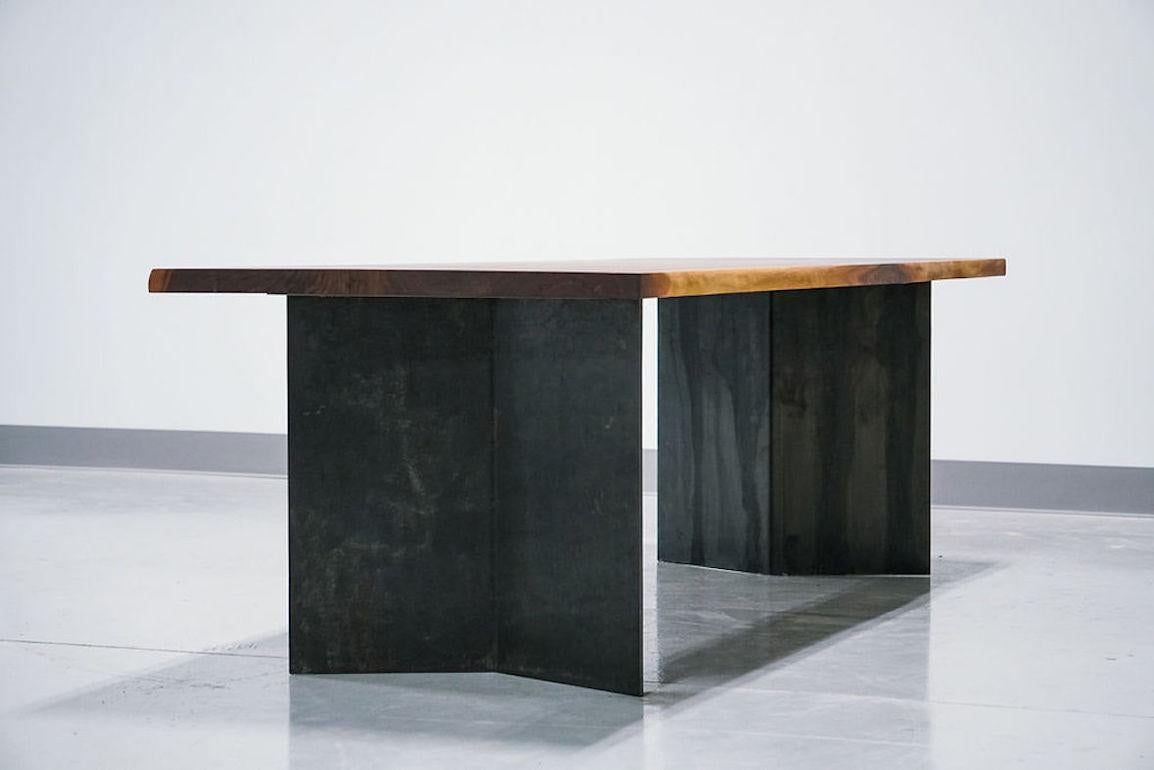 A mix of organic and industrial design, the Dock table features sustainable walnut and raw steel. The top is joined and glued before being hand-sculpted along the grain to feature an organic edge. The base is constructed from 1/4 inch hot rolled
