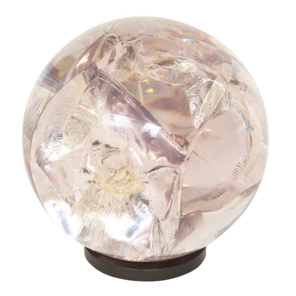 Fractured resin lucite sphere, bronze base. Large-scale clear acrylic sphere with a hint of light pink tone. The fracturing of the resin is achieved by running electric current into the acrylic mold when the acrylic is still in liquid form.
