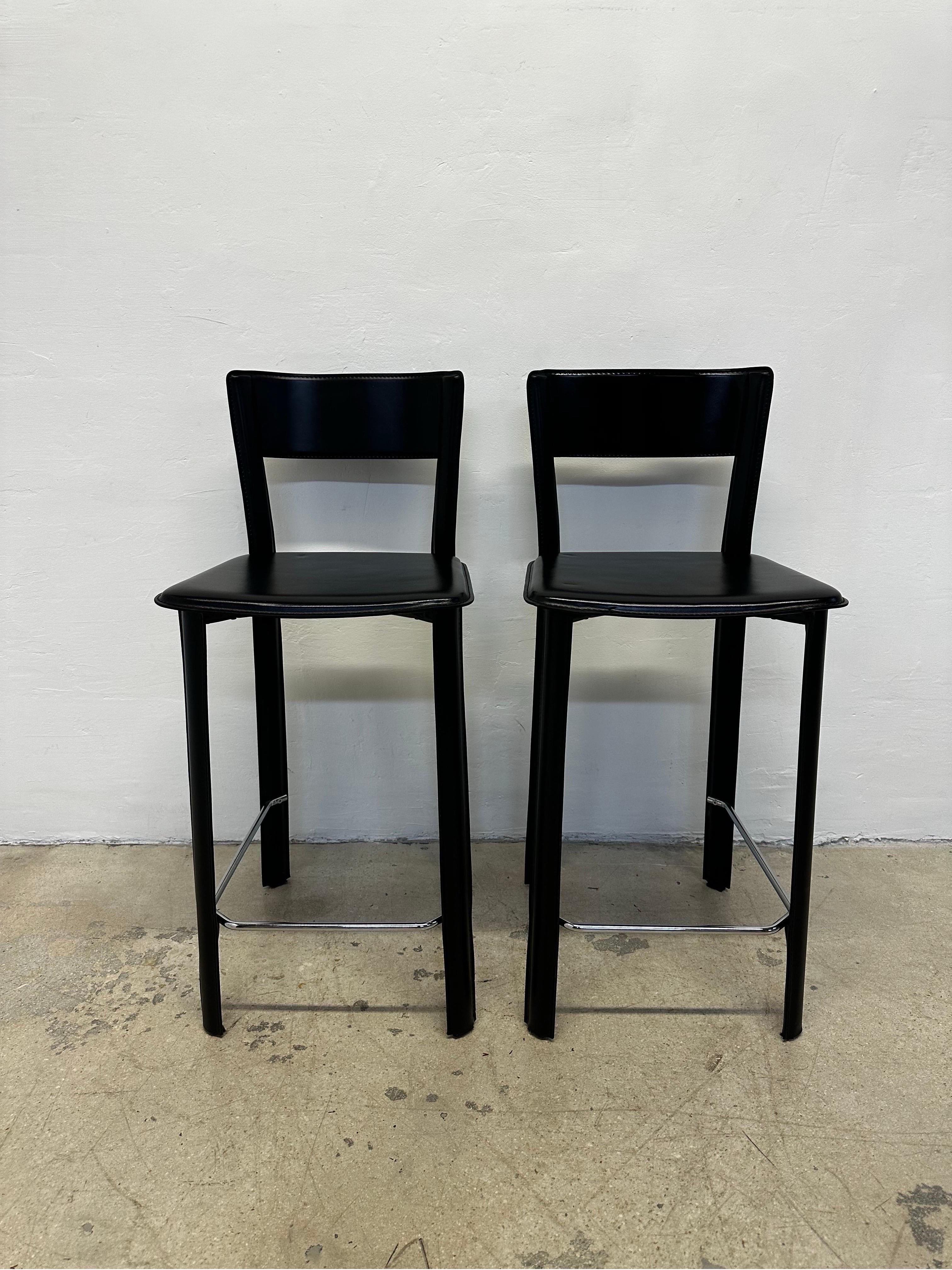 Pair of stitched Italian black leather counter stools with chrome foot rests by Frag Italy.