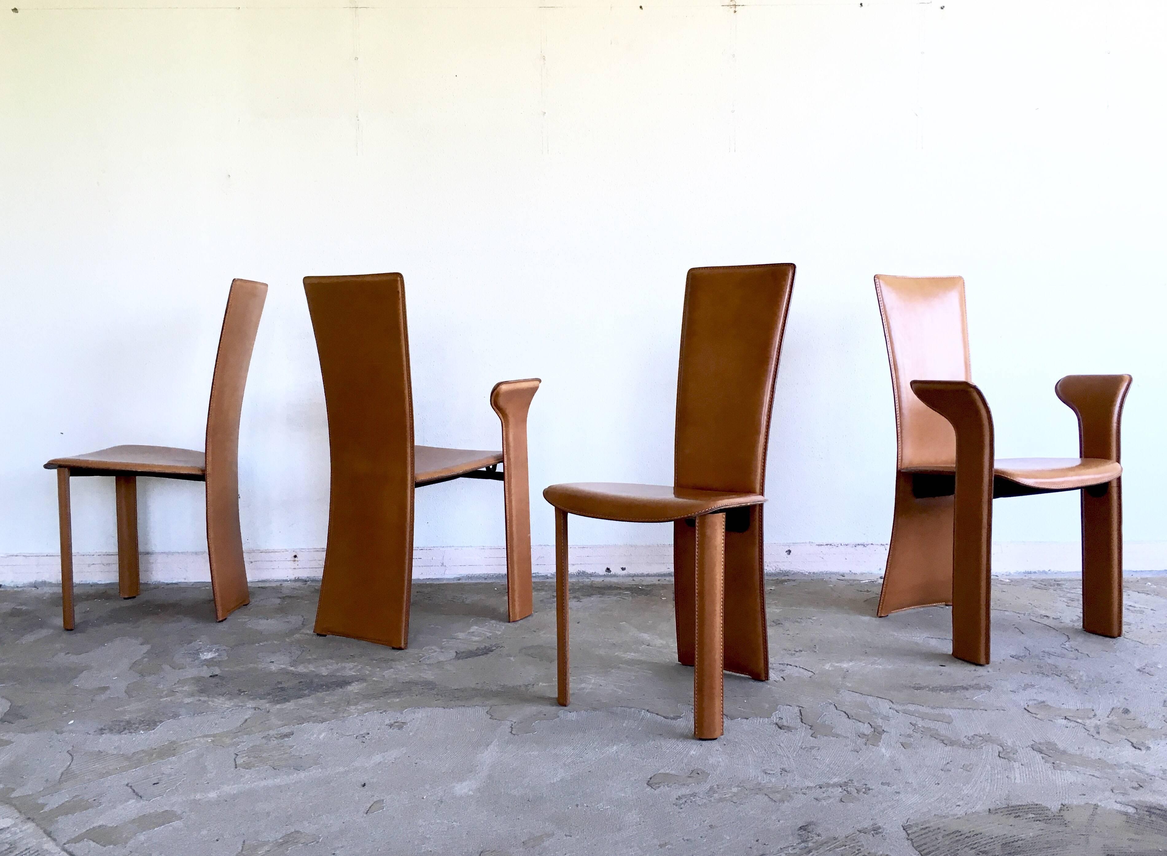 Gorgeous set of four dining chairs with thick leather upholstery. The chairs were manufactured by frag Italy and remain in good condition with wear consistent with age and use. Elegant and also industrial looking pieces. Marked and imprinted with