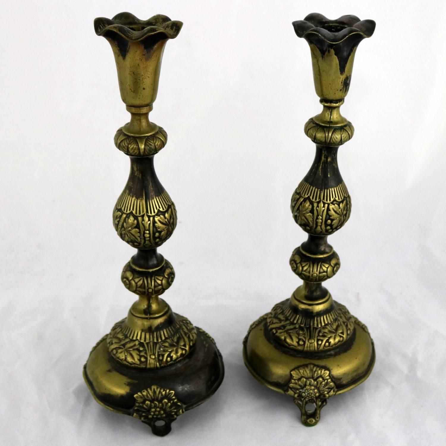 Beautiful pair of antique Judaica. These Sabbath candlesticks by Fraget N Plaque have a gorgeous distressing and age patina. They are dented and bent and cracked and most of the silver plate is off but they are fabulous in their distressing. Each is