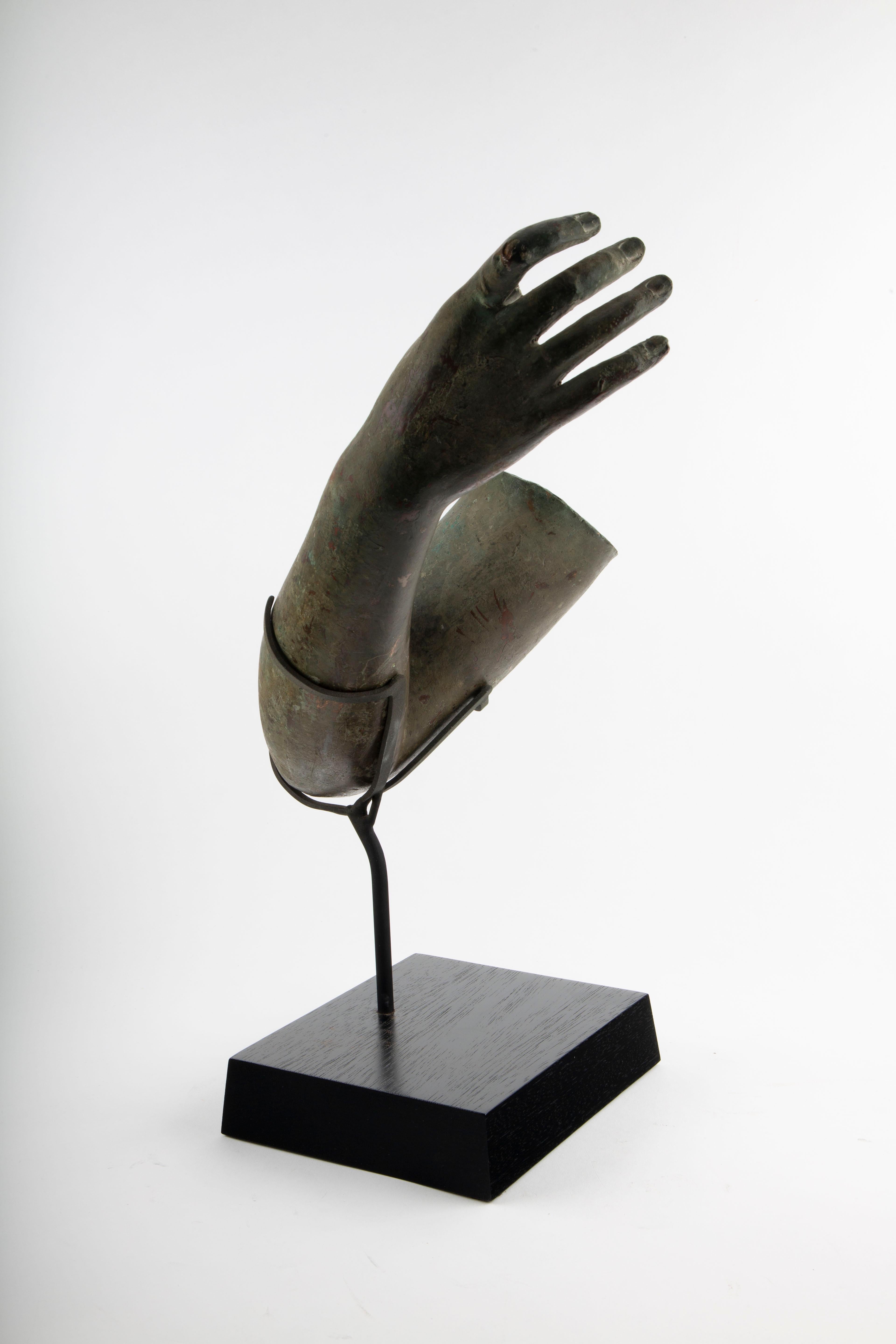 Fragment of a Bronze Arm
Mounted Green-Patinated Bronze Sculpture

A Grand Tour–style early 20th-century fragment of a bronze arm, this evocative sculptural remnant captures a lifelike limb bent elegantly at the elbow and culminating in an