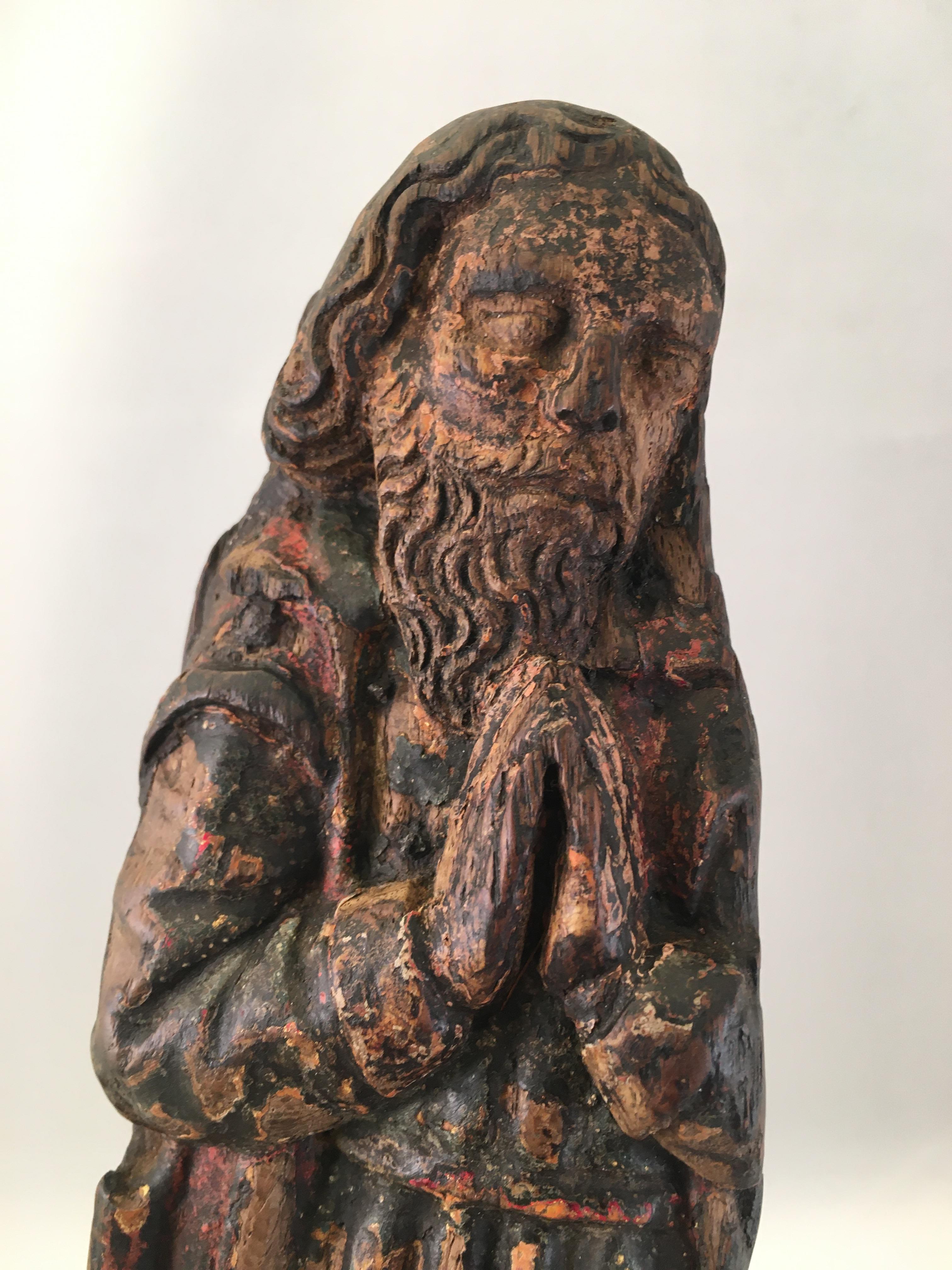 A wooden fragment with remains of original polychrome from a male saint, France, end of the 15th century (circa 1500).
A small but very detailed sculptured statue of a praying male saint. Probably an applique from a cabinet.