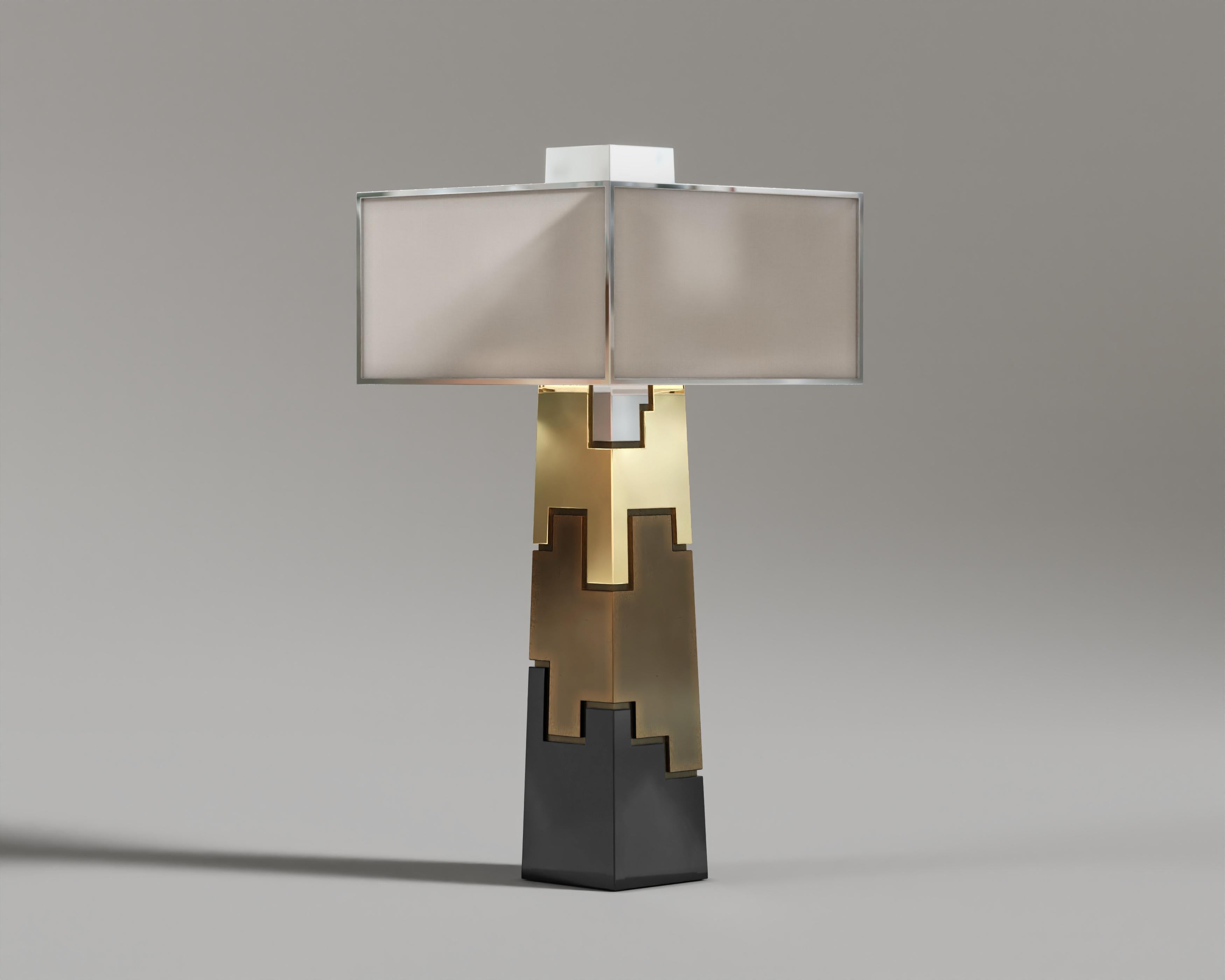 Fragmin Table Lamp

Fragmin Table Lamp, a mesmerizing piece that is made from top of the range metals – black lacquer, polished bronze, patine bronze, and stainless steel layers, is modeled like a fashionable Lego block.

The rectangular lampshade