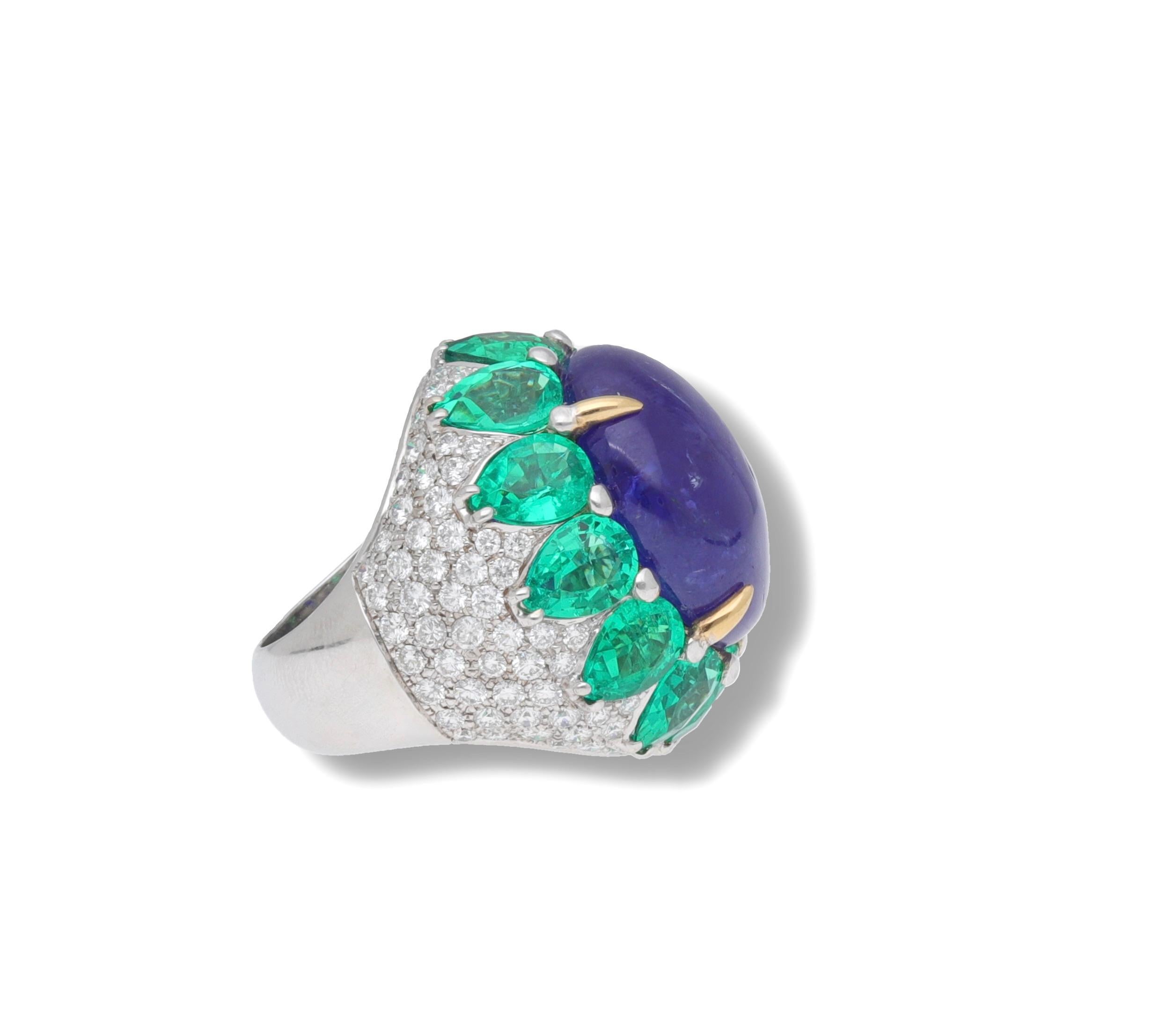 Handmade in Italy 18 kt. white gold ring with diamonds, lab-created emeralds and tanzanite cabochon.
This ring belongs to the Queen Fraleoni Collection and is a unique piece.
The central tanzanite is surrounded by a crown of lab-created emeralds